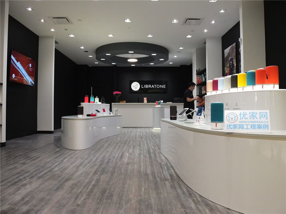 Contemporary retail store renovation inside Markville Mall featuring custom curved display counters, modern commercial flooring, integrated ceiling lighting, and sleek black feature walls. The design enhances product presentation while creating an open and welcoming shopping environment. This commercial renovation showcases how thoughtful retail layout planning and durable finishes can improve customer flow and elevate the in-store shopping experience in a busy Toronto mall.