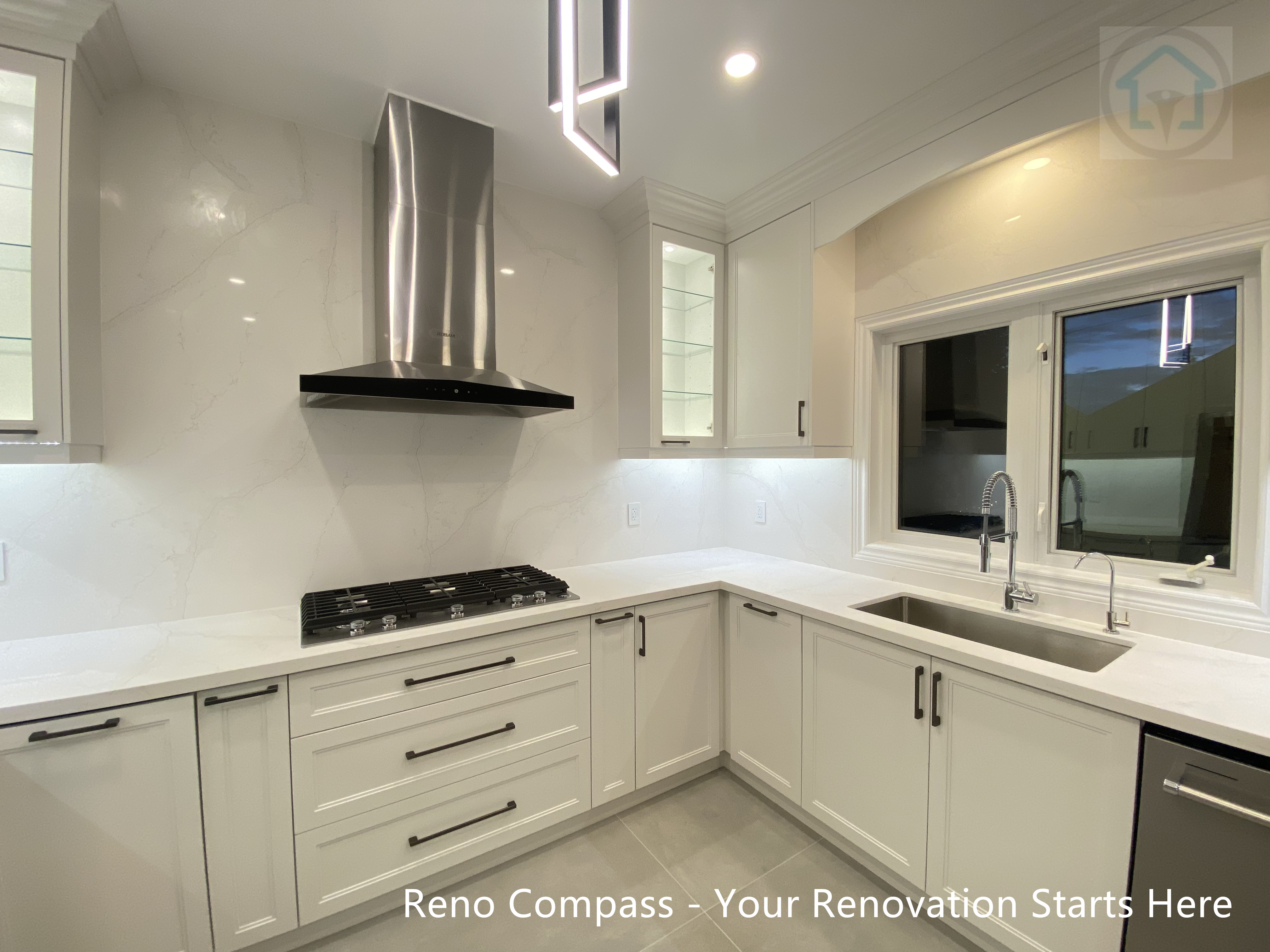 Modern Oakville kitchen renovation highlighting an undermount stainless steel sink positioned beneath a large window, maximizing natural light while enhancing functionality and visual openness in the workspace.