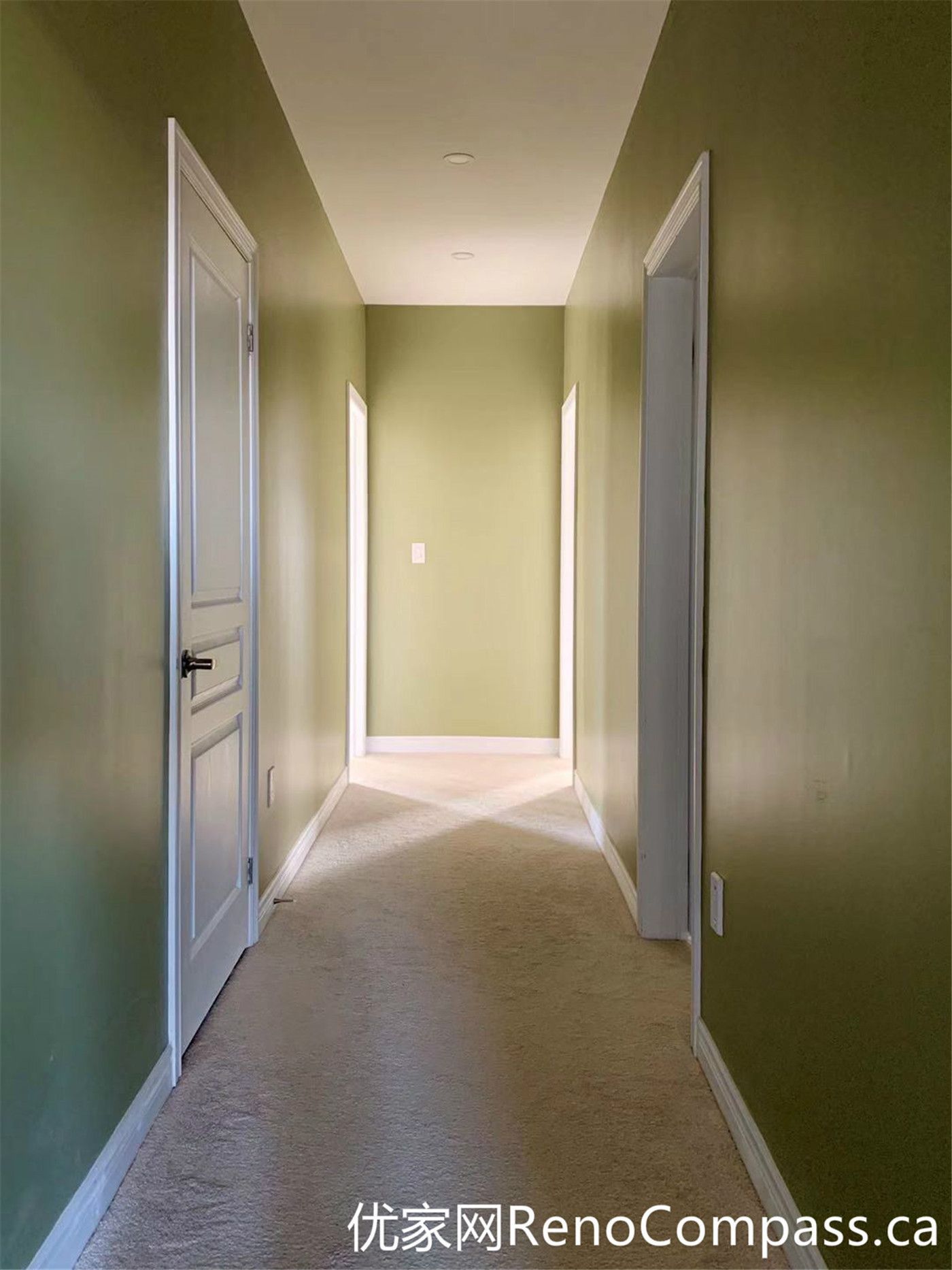 This hallway from a Markham full home renovation features soft green walls, clean white trim, and a simple, functional layout. Natural light enhances the depth of the space, while the updated finishes create a cohesive transition between rooms with a calm and modern feel.