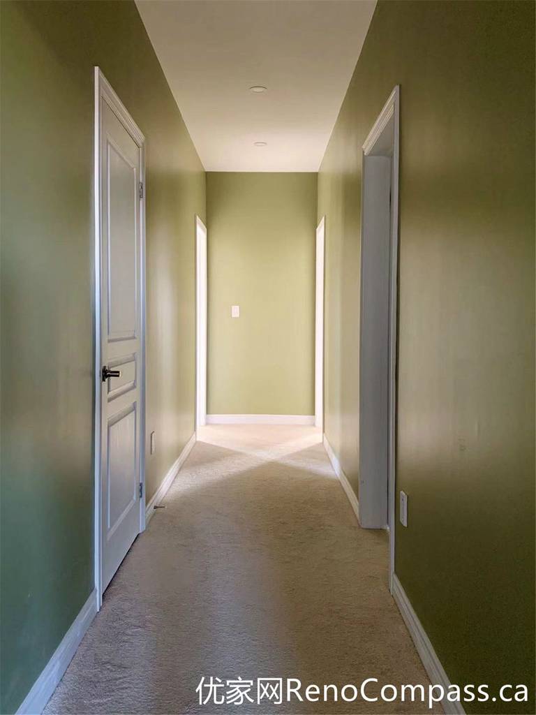 This hallway from a Markham full home renovation features soft green walls, clean white trim, and a simple, functional layout. Natural light enhances the depth of the space, while the updated finishes create a cohesive transition between rooms with a calm and modern feel.