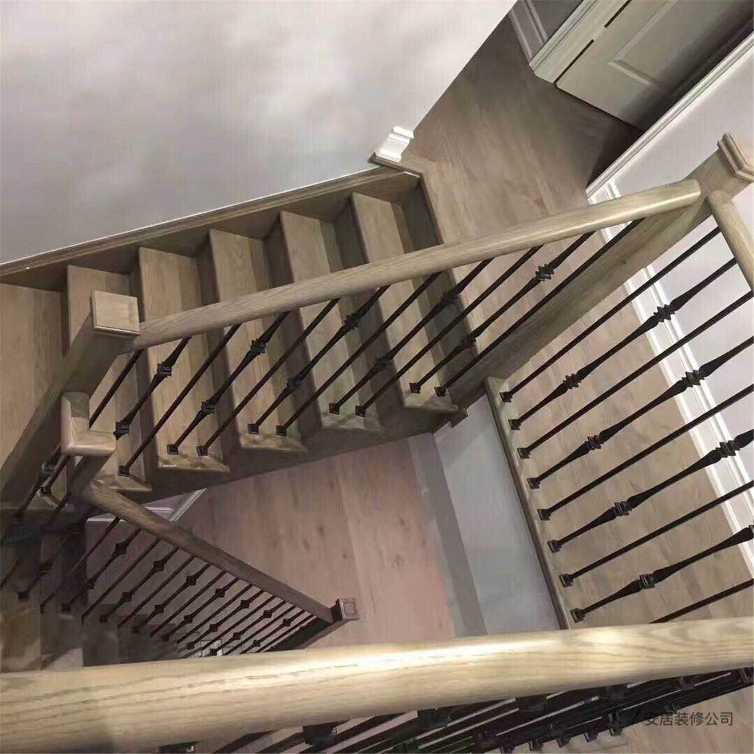 This Scarborough interior renovation features a beautifully upgraded staircase with warm wood stair treads and modern black iron railings. The clean lines and neutral color palette create a contemporary yet timeless look that complements the surrounding flooring and wall finishes. The staircase design enhances both safety and visual appeal, adding architectural character to this renovated Scarborough home interior.