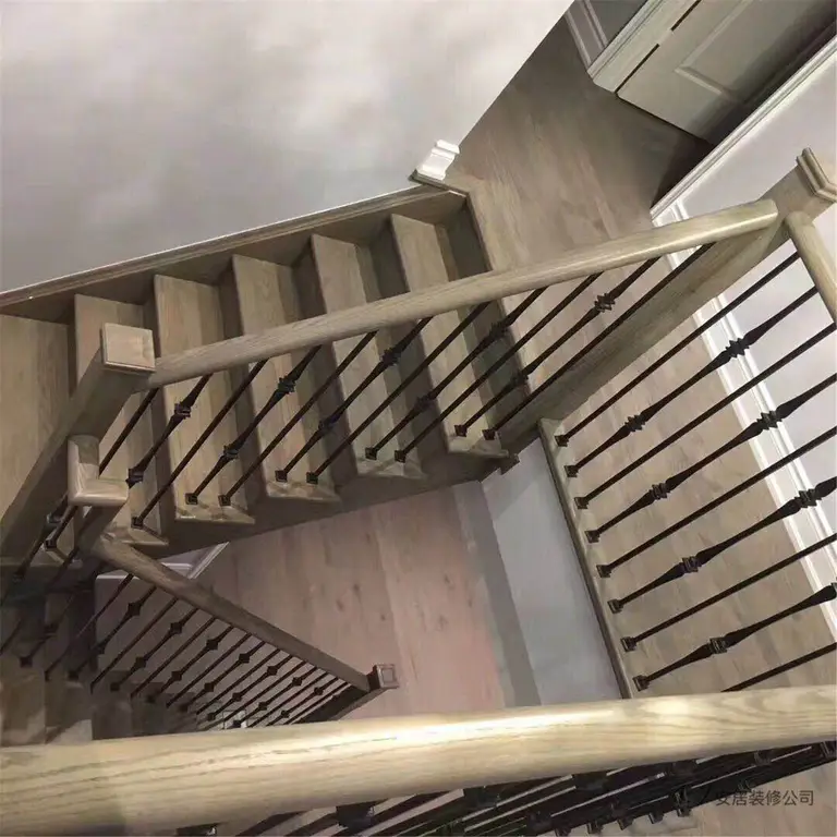 This Scarborough interior renovation features a beautifully upgraded staircase with warm wood stair treads and modern black iron railings. The clean lines and neutral color palette create a contemporary yet timeless look that complements the surrounding flooring and wall finishes. The staircase design enhances both safety and visual appeal, adding architectural character to this renovated Scarborough home interior.