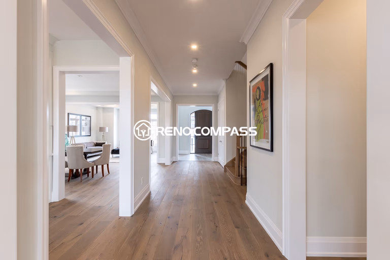 This image shows a Newmarket home flooring renovation project, featuring professionally installed engineered wood flooring throughout the hallway and living space. Engineered wood flooring offers the natural look of hardwood with improved stability and durability.

The flooring upgrade creates a clean and modern interior and was completed by Reno Compass Inc., a Toronto renovation company specializing in flooring and interior renovations.