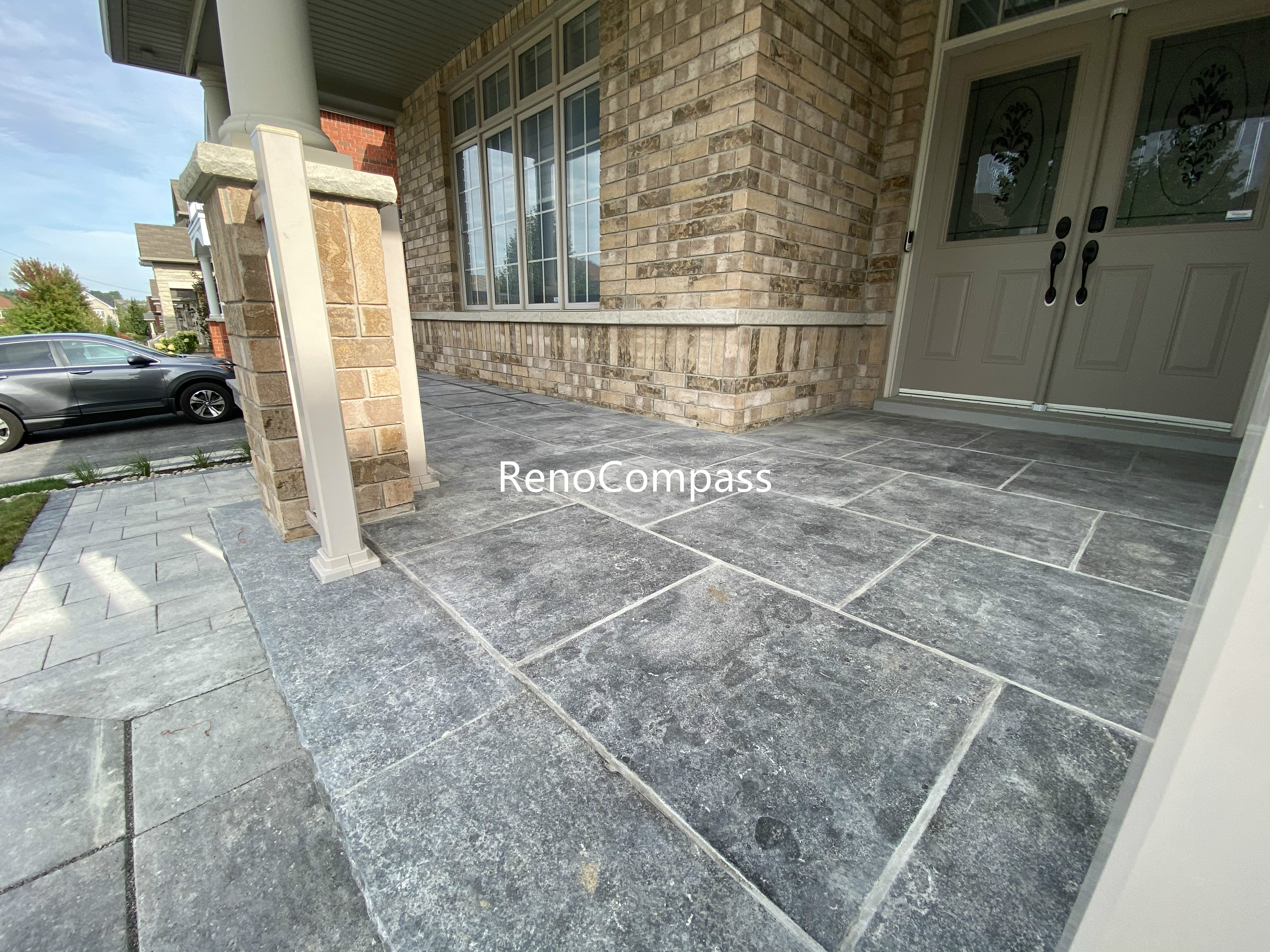 This Aurora front porch interlocking project showcases a refined entrance design using large-format concrete pavers with a natural stone texture. The precise layout enhances both durability and visual balance, creating a clean and welcoming transition from the driveway to the main entrance. Neutral grey tones complement the home’s brick exterior while providing a slip-resistant and low-maintenance surface. This professionally installed interlock porch improves curb appeal, functionality, and long-term performance for residential properties in Aurora.