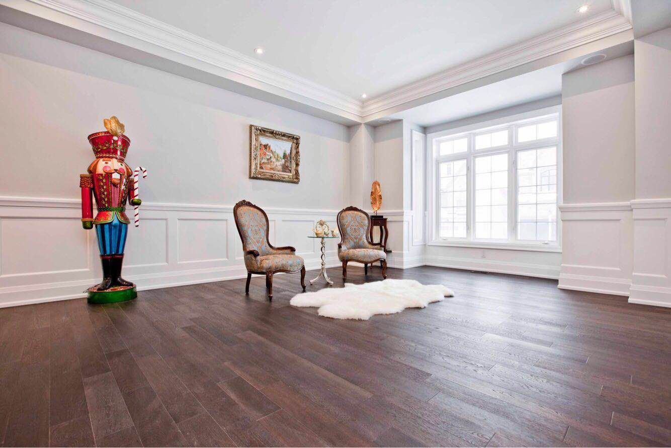 Luxury interior space completed as part of a Toronto design build custom build project, featuring open-concept dining and living areas, hardwood flooring, coffered ceilings, and elegant lighting details. This whole house renovation Toronto project highlights high-end craftsmanship, spacious layout planning, and refined architectural finishes typical of premium custom home construction in Toronto.