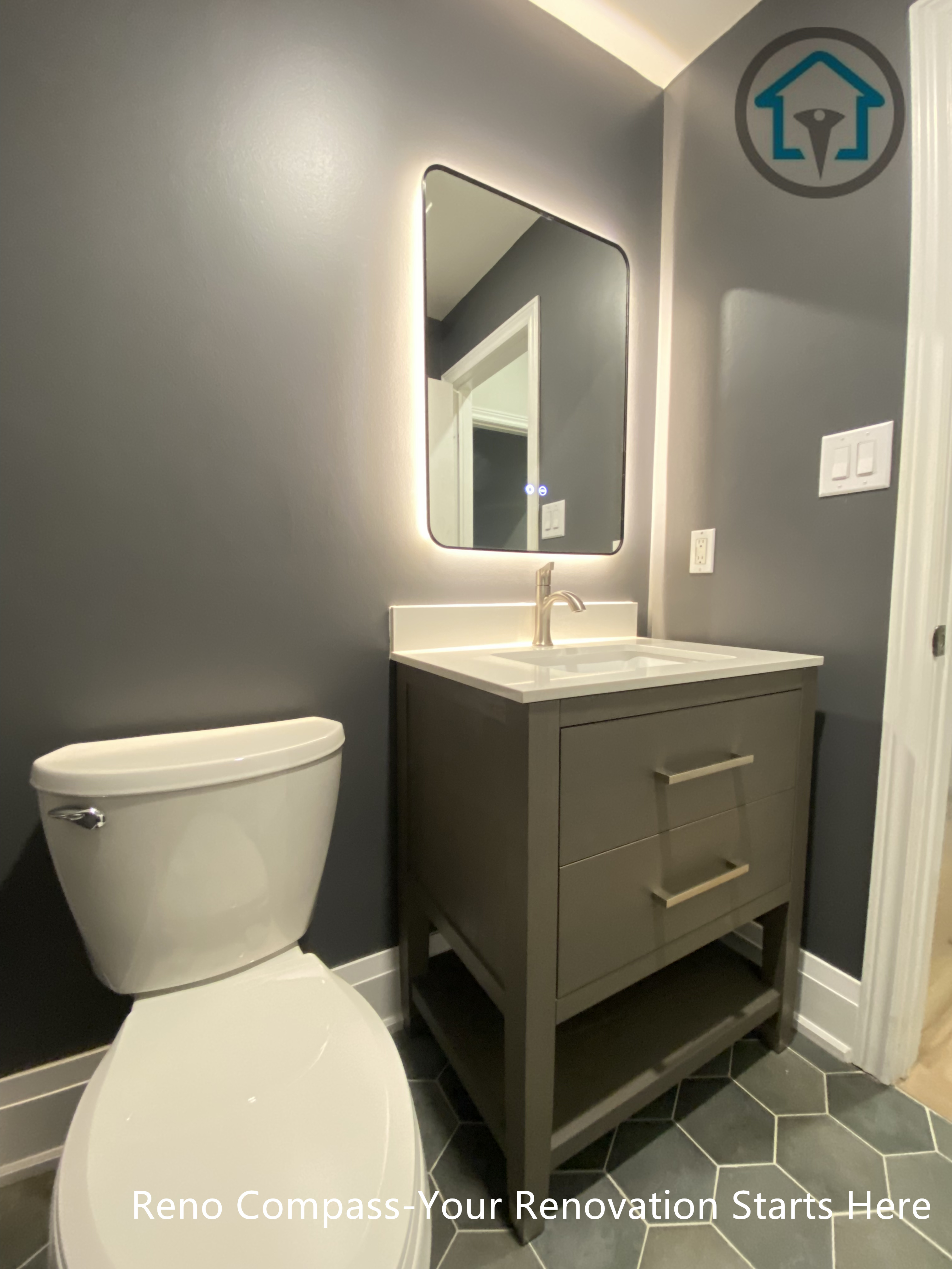 This Richmond Hill bathroom renovation features a modern powder room design with a compact vanity, backlit mirror, and dark wall finishes. The layout maximizes functionality in a small space while maintaining a clean, contemporary look, completed by a trusted Toronto renovation company.