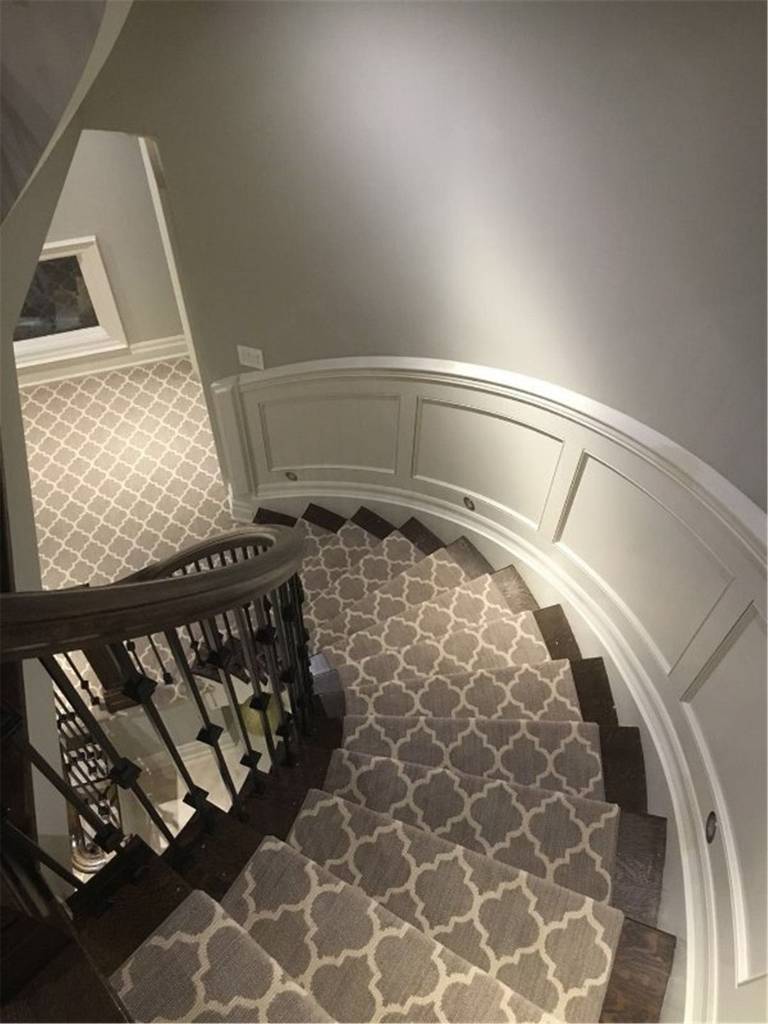 This Toronto interior renovation project features a custom curved staircase carpet installation designed to enhance both safety and visual elegance. The patterned stair runner was carefully measured and fitted along the curved staircase to ensure seamless alignment and long-term durability. Paired with dark wood stair treads, classic wall paneling, and neutral wall tones, the carpet adds warmth, comfort, and a refined finish to the home’s interior.

Installed by an experienced Toronto renovation company, this project highlights precise workmanship, detailed stair fitting, and high-quality materials, creating a timeless and functional staircase upgrade suitable for modern residential interiors.