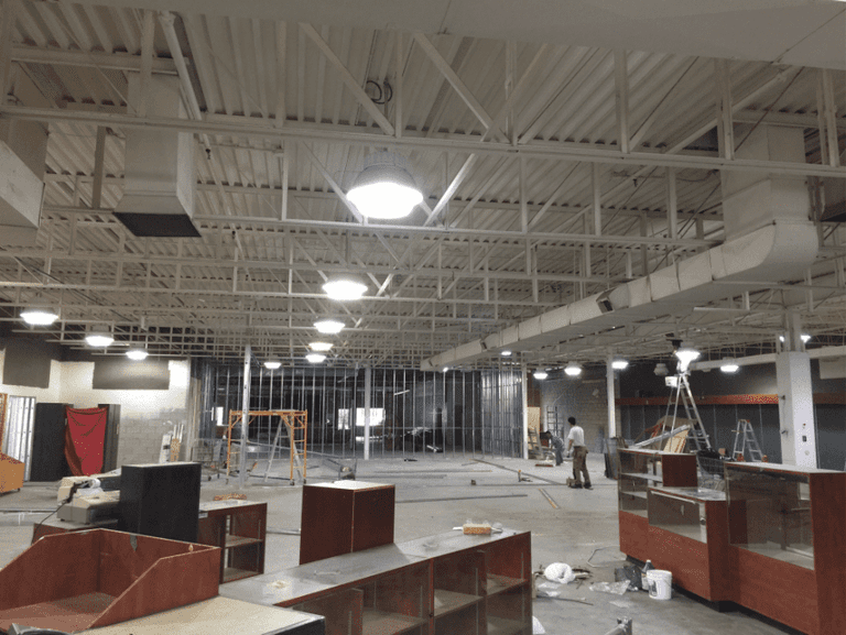 This outdoor equipment retail store renovation showcases a spacious open-concept layout with newly installed durable vinyl flooring, modern ceiling lighting, and custom display shelving. Reno Compass Inc. transformed the commercial space into a clean, functional, and customer-friendly retail environment, ideal for showcasing outdoor products while ensuring long-term durability and easy maintenance.