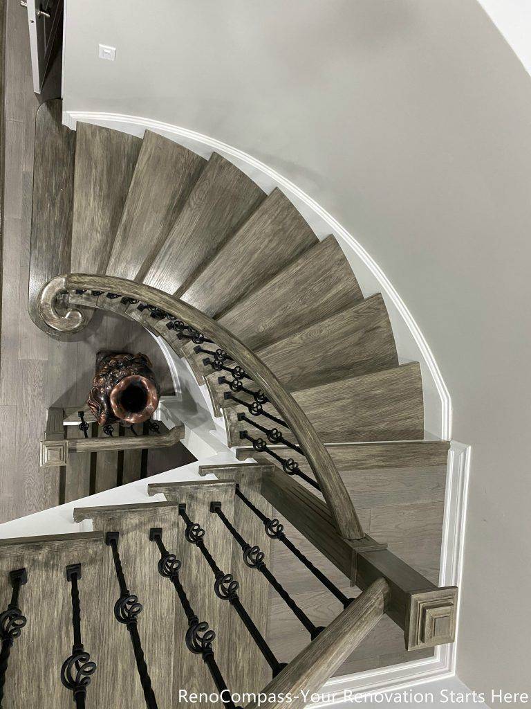 This Mississauga interior renovation features a beautifully crafted curved staircase with custom wood treads, modern iron balusters, and elegant trim detailing. The upgraded staircase enhances the home’s architectural character while improving durability and safety. Paired with new flooring and clean contemporary finishes, the design creates a striking focal point that connects multiple levels seamlessly. Completed by a professional Toronto renovation company, this renovation highlights quality craftsmanship and modern interior design that elevates both visual appeal and property value.