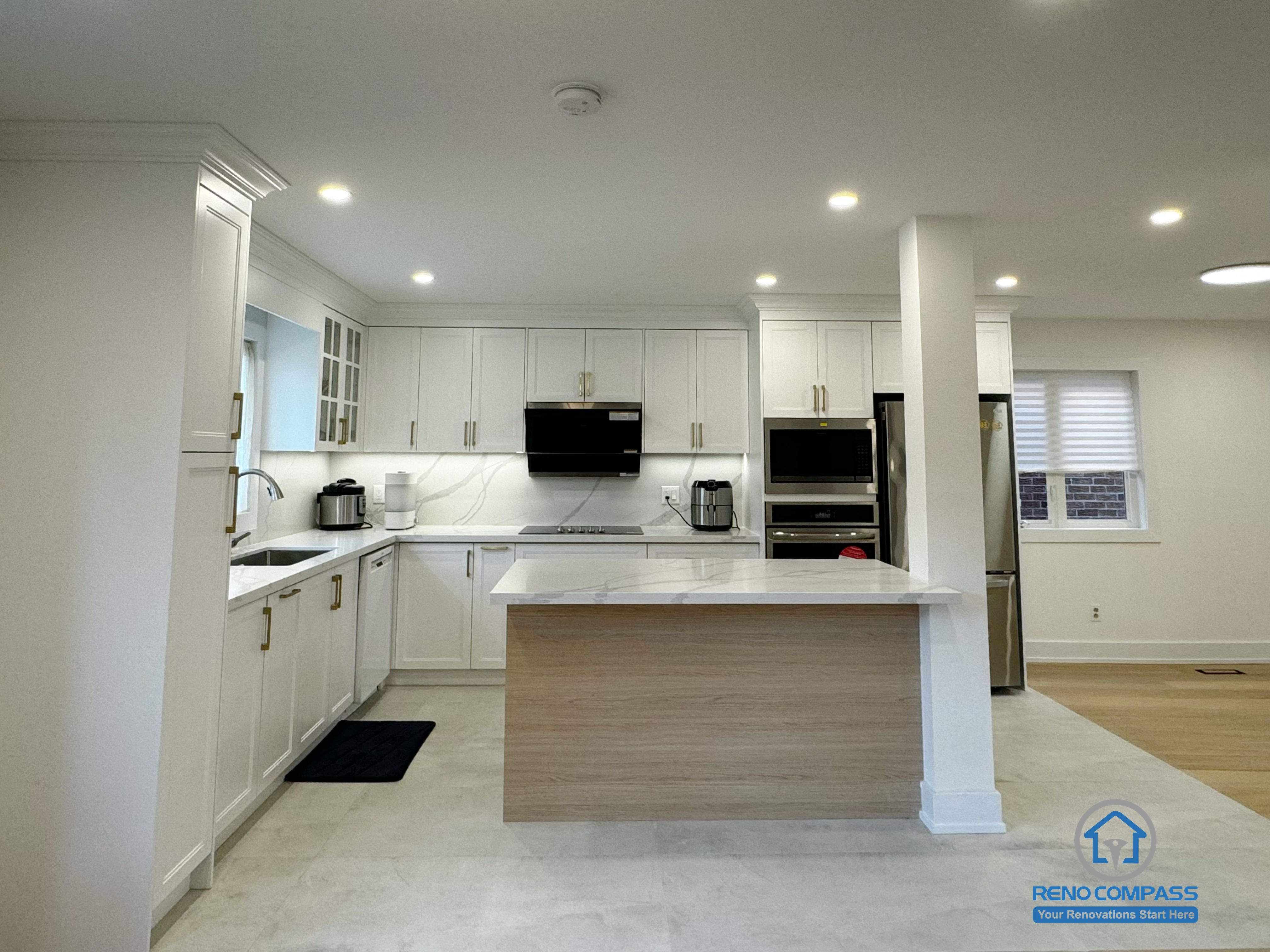 This Richmond Hill kitchen renovation showcases an open-concept layout with a central island that improves circulation and everyday usability. Custom white cabinetry, integrated appliances, and clean-lined finishes create a bright and cohesive cooking space. Thoughtful lighting and balanced proportions enhance both function and visual clarity, making this kitchen a seamless part of the overall Toronto renovation focused on comfort, durability, and long-term living quality.