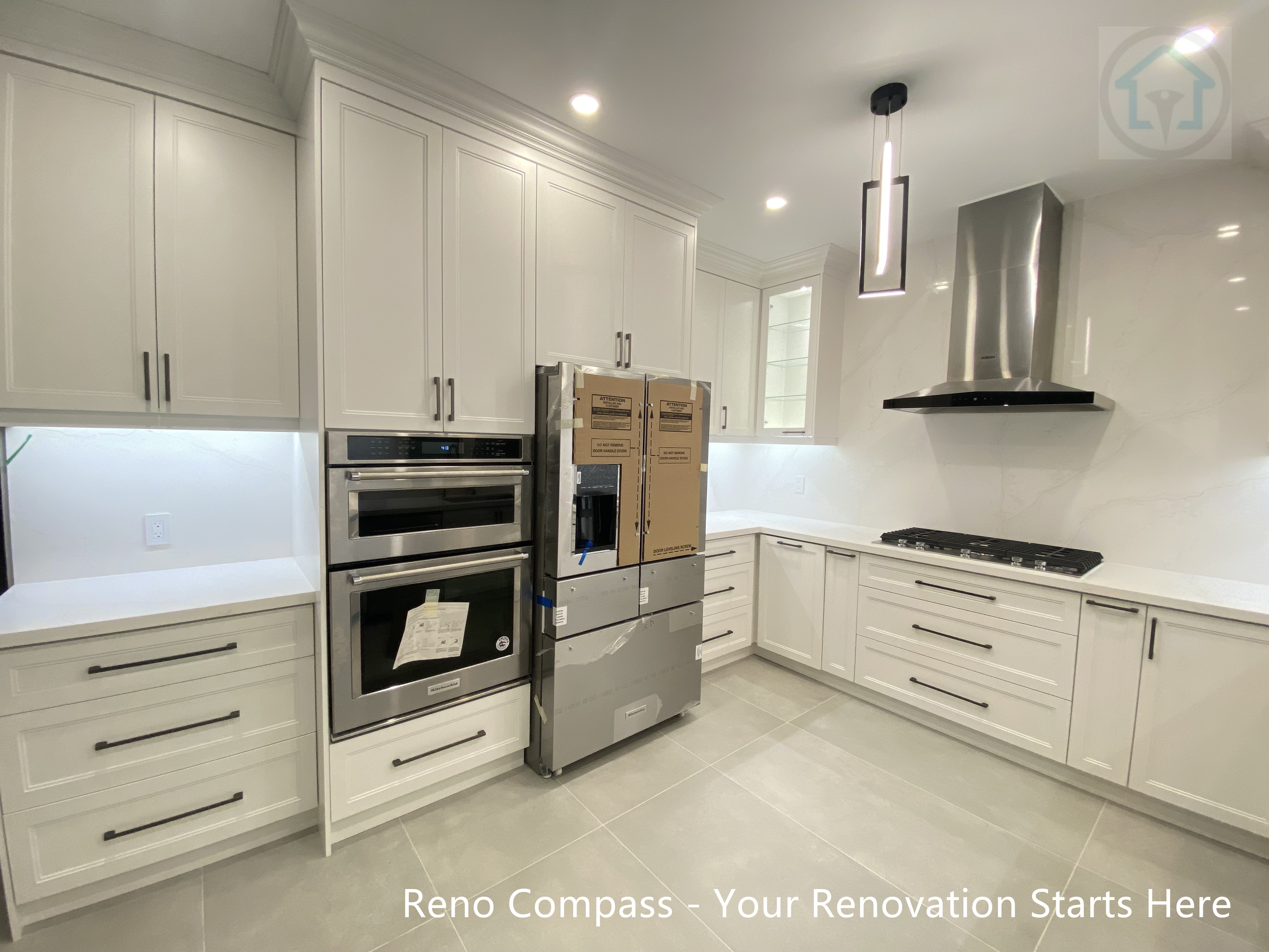Detailed view of an Oakville kitchen renovation featuring glass upper cabinets with integrated LED lighting, combining practical storage solutions with a refined and contemporary design aesthetic.
