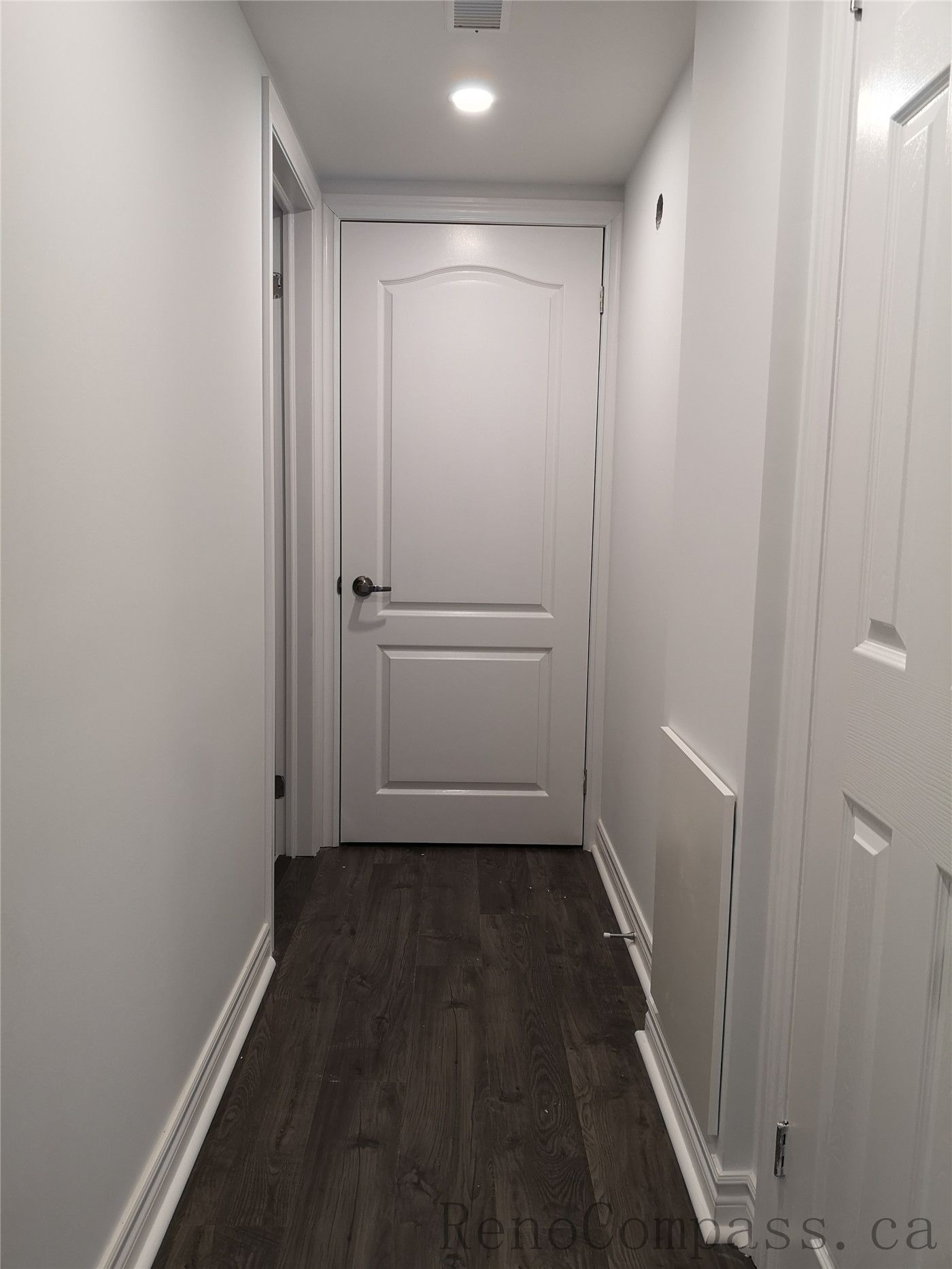 This Richmond Hill basement renovation includes a clean and modern hallway design featuring new interior doors, recessed pot lighting, and durable wood flooring. The neutral wall color and upgraded trim create a bright and cohesive transition between basement rooms. Completed by a trusted Toronto renovation company, Reno Compass Inc., this finished basement hallway enhances both functionality and visual flow throughout the space.