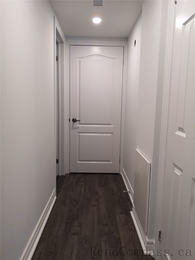 This Richmond Hill basement renovation includes a clean and modern hallway design featuring new interior doors, recessed pot lighting, and durable wood flooring. The neutral wall color and upgraded trim create a bright and cohesive transition between basement rooms. Completed by a trusted Toronto renovation company, Reno Compass Inc., this finished basement hallway enhances both functionality and visual flow throughout the space.