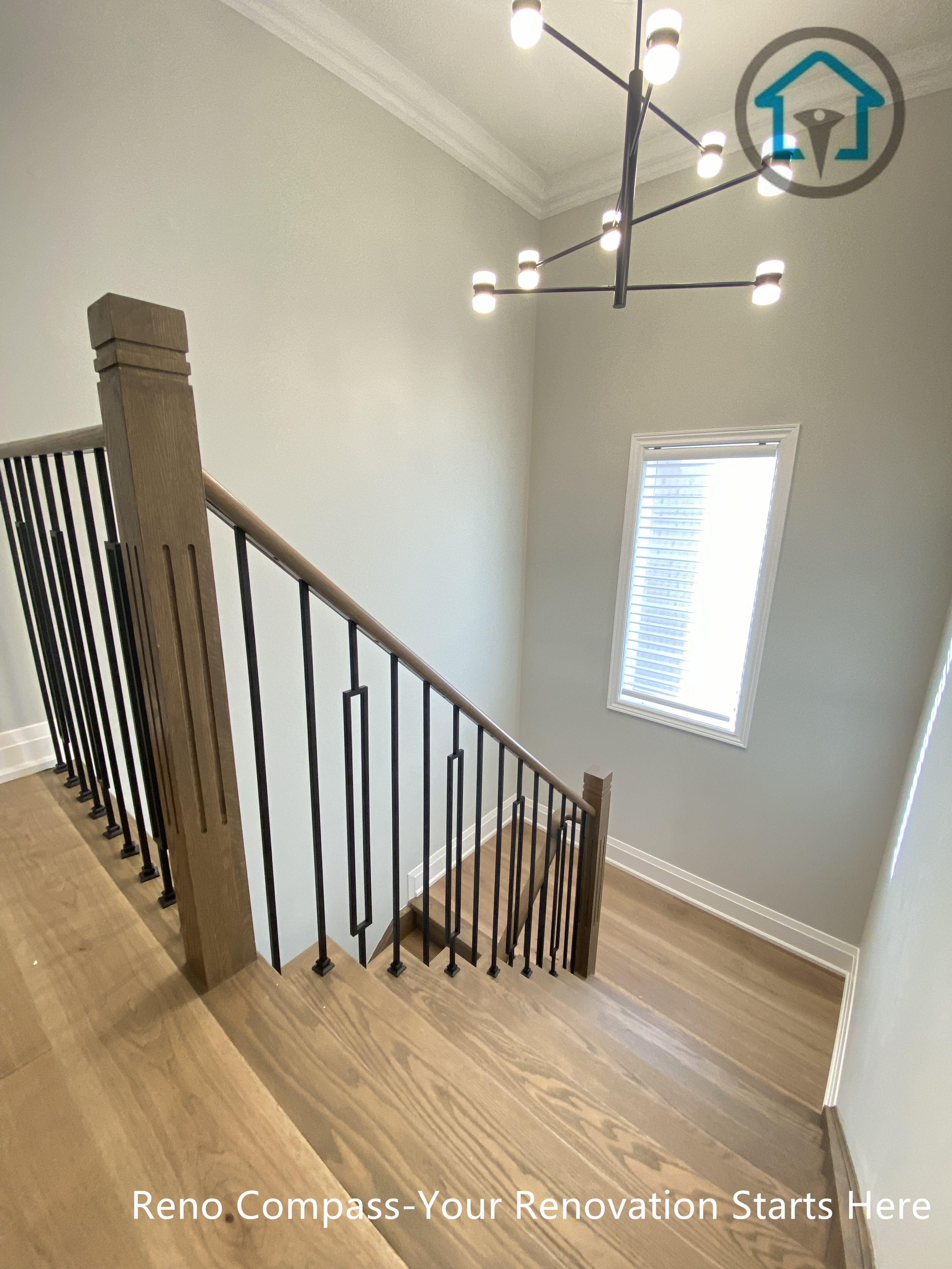 This image showcases a completed flooring and staircase renovation project in Richmond Hill, featuring modern wood stair treads, matching hardwood flooring, and sleek black iron railings. The updated staircase design enhances safety, flow, and visual continuity between levels, creating a bright and contemporary interior look. Completed by an experienced Toronto renovation company, the project focuses on durable materials, clean detailing, and long-term residential use.