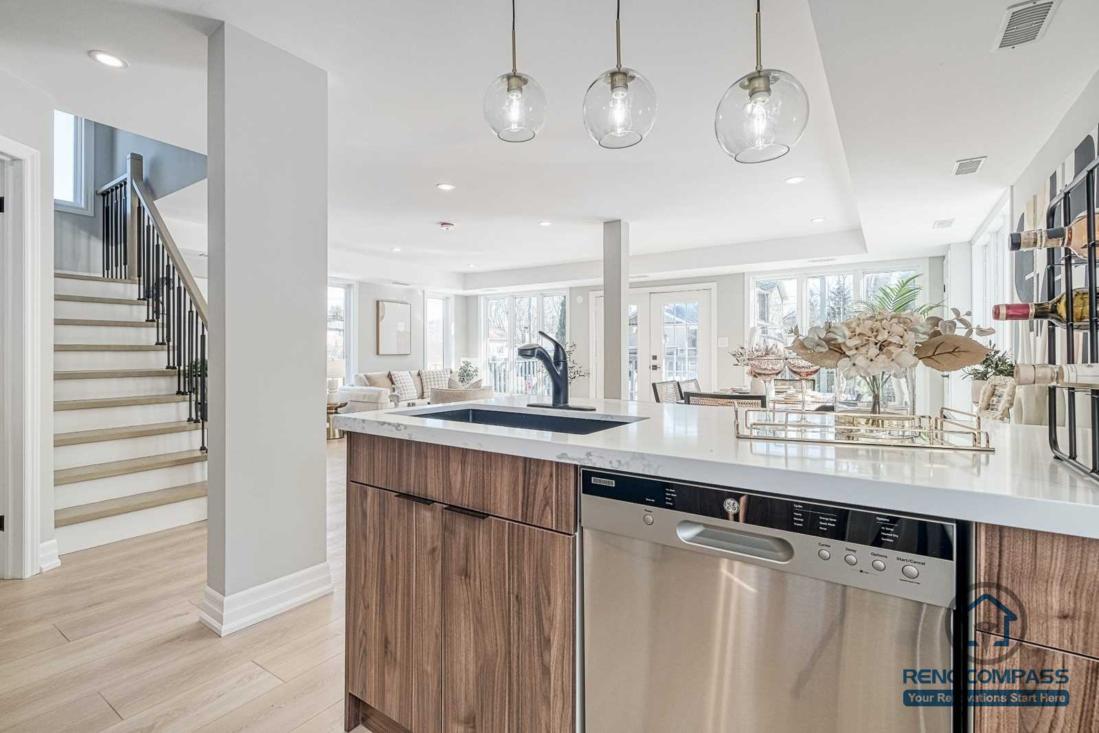 This Georgian interior renovation features a functional kitchen island with integrated appliances, pendant lighting, and seamless flow to the living and dining areas. Thoughtful layout and material selection reflect the quality of a Toronto renovation company.