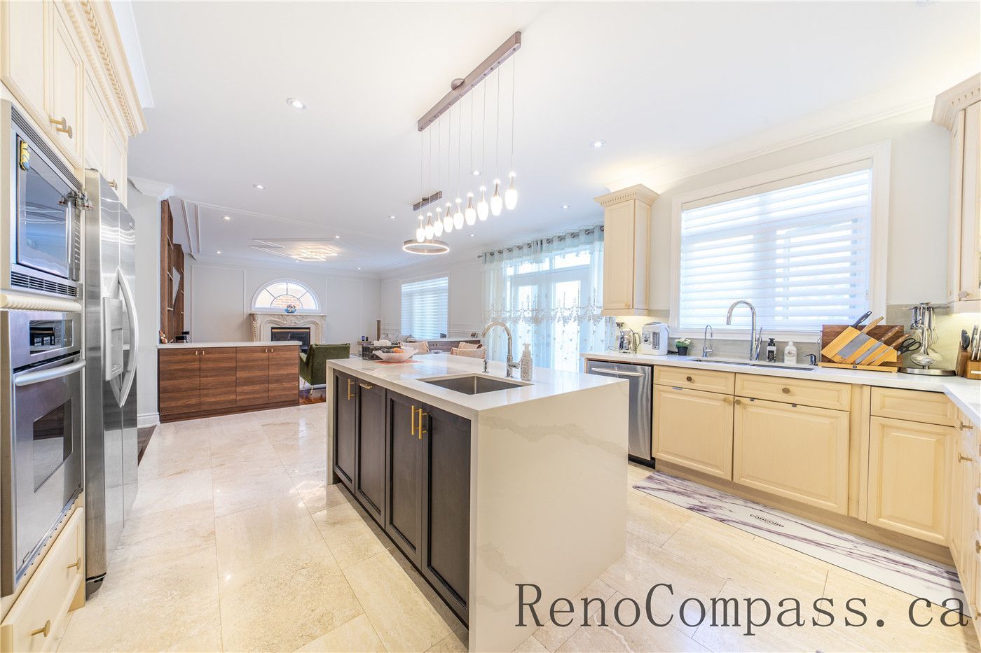 This Richmond Hill entire house interior renovation features a spacious luxury kitchen with a large central island, quartz countertops, and custom cabinetry. Modern pendant lighting and built-in appliances enhance both functionality and style, while the open-concept layout connects seamlessly to the living area. Designed for daily living and entertaining, this bright and elegant kitchen renovation was completed by a professional Toronto renovation company focused on craftsmanship, efficiency, and timeless design.