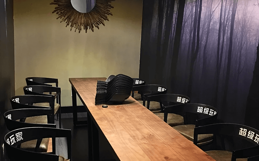 This commercial interior design project in Toronto features a modern meeting and lounge area designed for both collaboration and private discussions. The space combines warm wood textures, sleek black seating, and ambient lighting to create a refined and comfortable environment. A custom wood conference table anchors the room, while artistic wall décor and atmospheric feature walls enhance the overall visual experience.

Designed and built by a professional Toronto commercial renovation team, this space reflects thoughtful layout planning, functional seating arrangements, and a contemporary aesthetic ideal for private clubs, gaming lounges, creative studios, or business meeting areas.