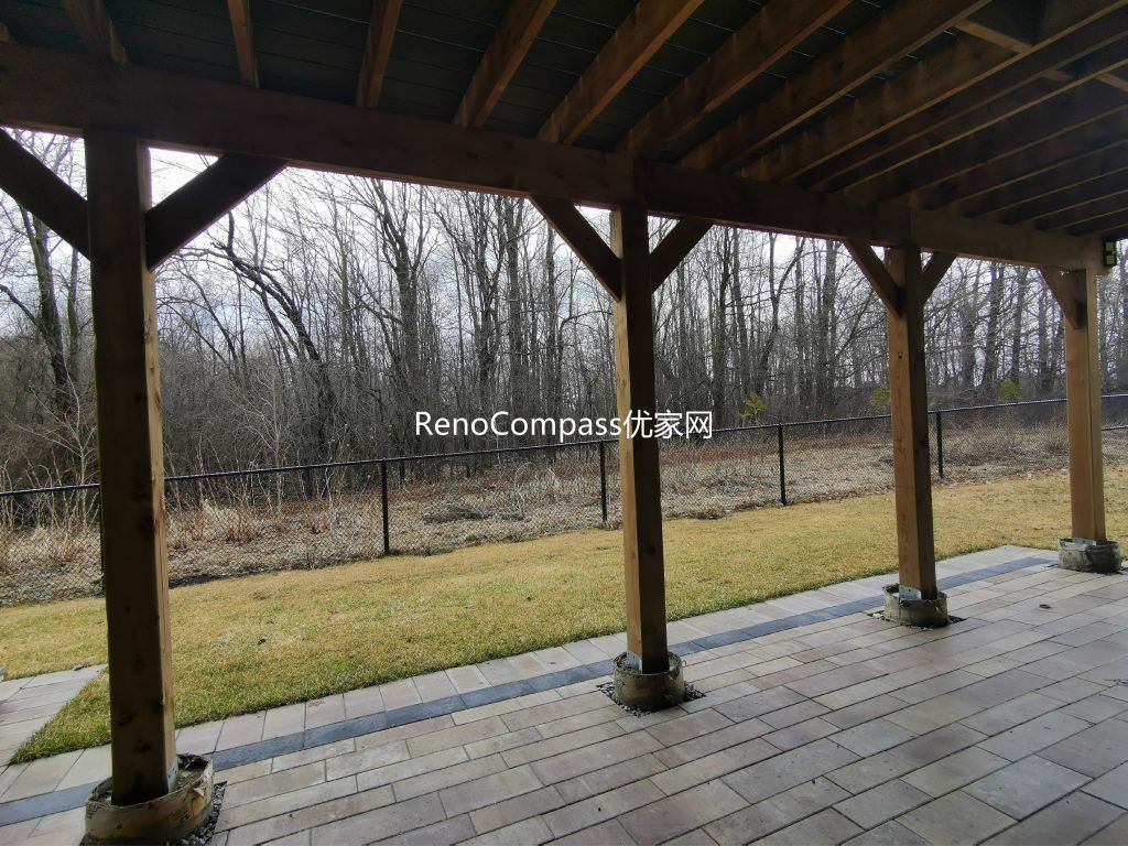 Custom elevated deck renovation in Aurora featuring composite decking, modern glass and aluminum railings, and a covered patio structure below. This professionally built outdoor space provides added functionality, weather protection, and a stylish backyard upgrade that enhances both usability and property value.