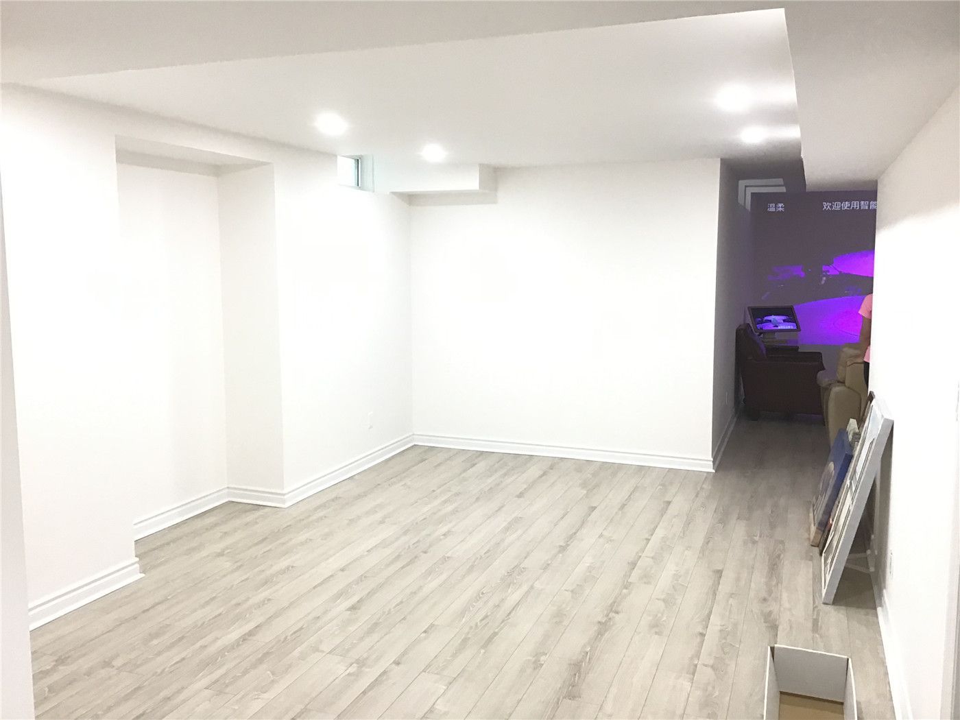 This Aurora basement renovation features a clean and open layout with light-toned flooring and recessed lighting, creating a bright and versatile space. The design allows for flexible use such as a living area, home office, or entertainment zone, maximizing functionality in the finished basement.