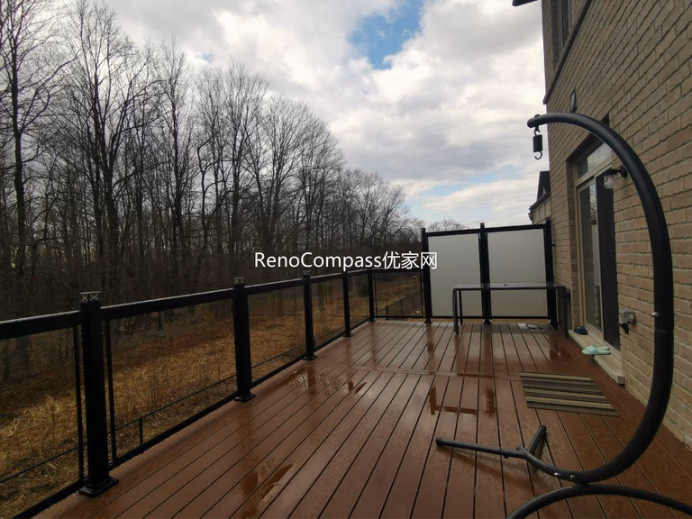 Professional deck construction project in Aurora featuring durable composite wood decking, modern black aluminum and glass railings, and a spacious outdoor layout. Designed for long-term durability and low maintenance, this backyard deck enhances outdoor comfort, safety, and property value.