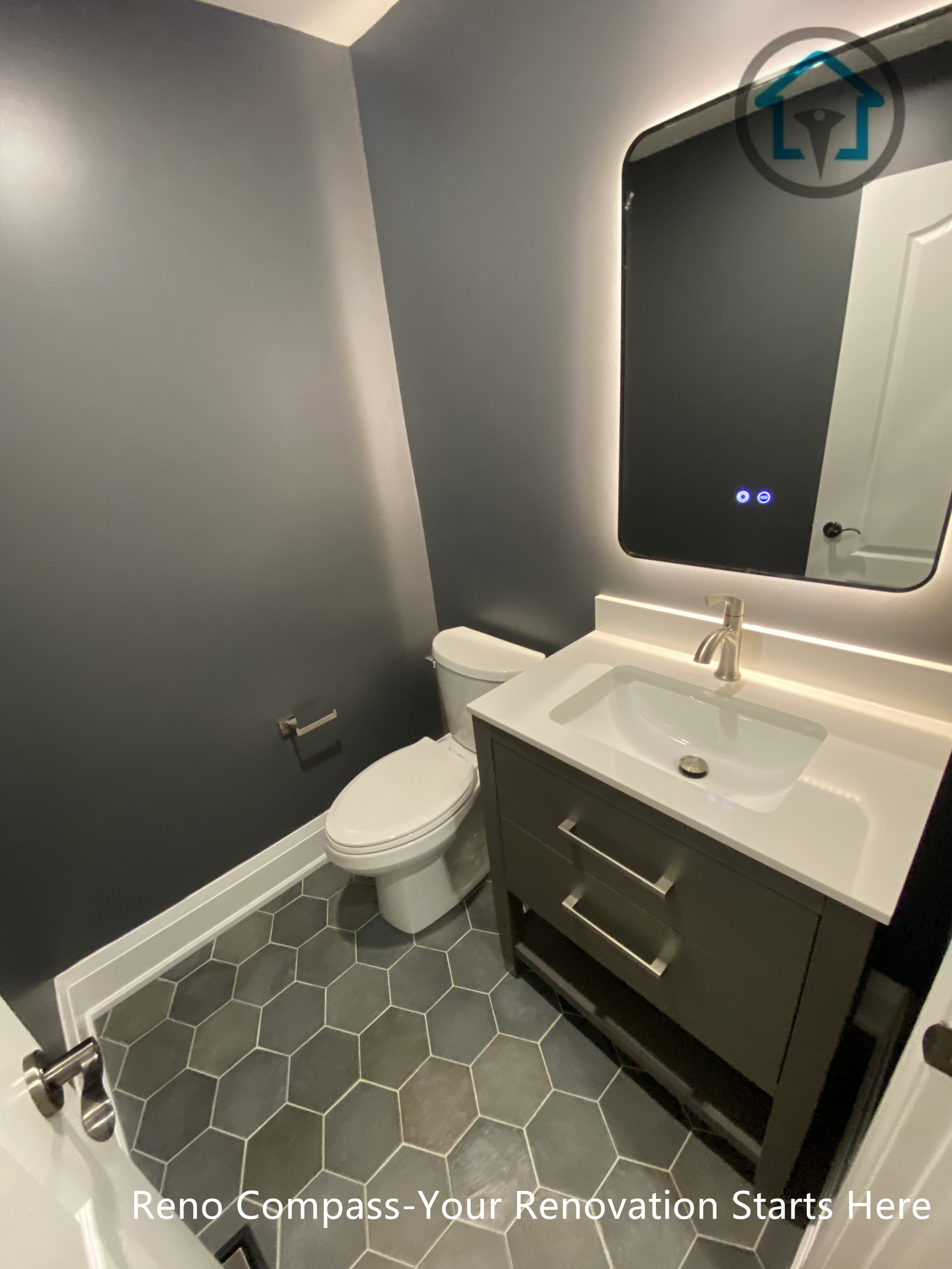 This Richmond Hill bathroom renovation features a modern powder room design with a compact vanity, backlit mirror, and dark wall finishes. The layout maximizes functionality in a small space while maintaining a clean, contemporary look, completed by a trusted Toronto renovation company.