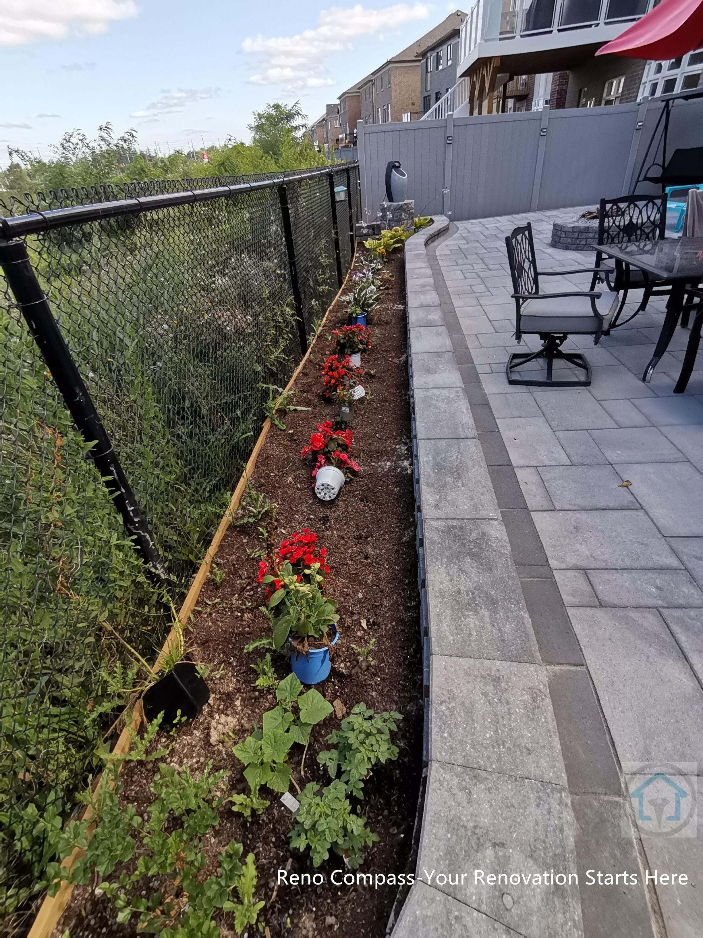This Vaughan backyard interlocking project features a clean stone walkway paired with a landscaped garden border. The interlocking pavers create a smooth circulation path along the patio, while the planting bed and fence line add structure, greenery, and visual depth to the outdoor space.