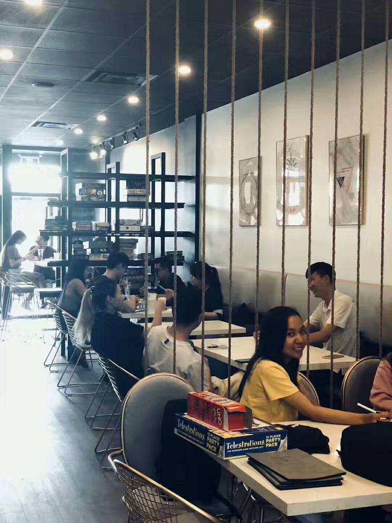 This image shows the seating area of a renovated bubble tea shop in Scarborough. The interior design features modern dining tables, comfortable seating, decorative rope dividers, and warm ceiling lighting that create a welcoming environment for customers. The open layout allows efficient use of space while maintaining a stylish and relaxed atmosphere. This commercial renovation project demonstrates thoughtful space planning and interior design tailored for a busy bubble tea shop.