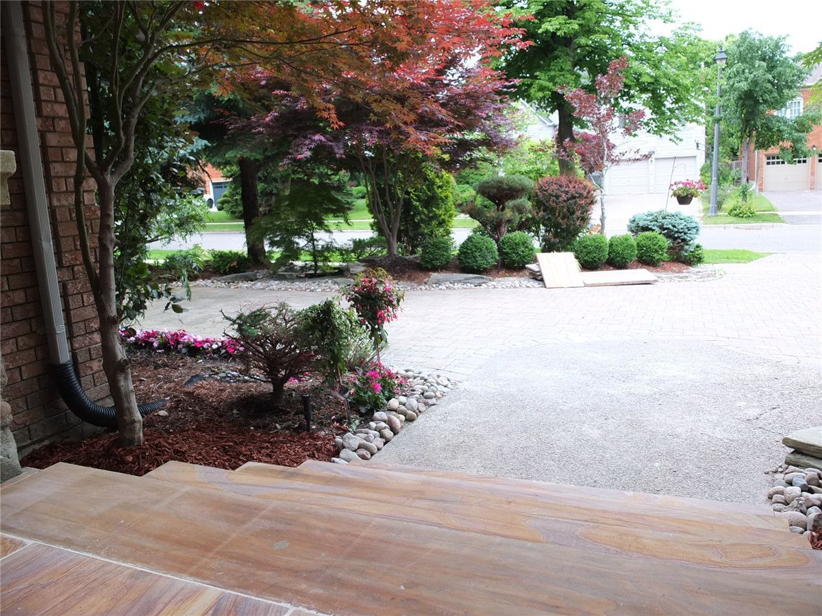 This Richmond Hill front entrance landscaping renovation showcases a professionally installed stone porch and interlock flooring designed to enhance both durability and curb appeal. High-quality natural stone tiles were carefully laid with precise alignment and proper base preparation to ensure long-lasting performance and weather resistance. The upgraded entrance area provides a clean, elegant transition to the main door while complementing the home’s brick exterior and surrounding stone features. Completed with expert craftsmanship, this front yard renovation improves functionality, safety, and overall exterior aesthetics for a refined and welcoming home entrance.
