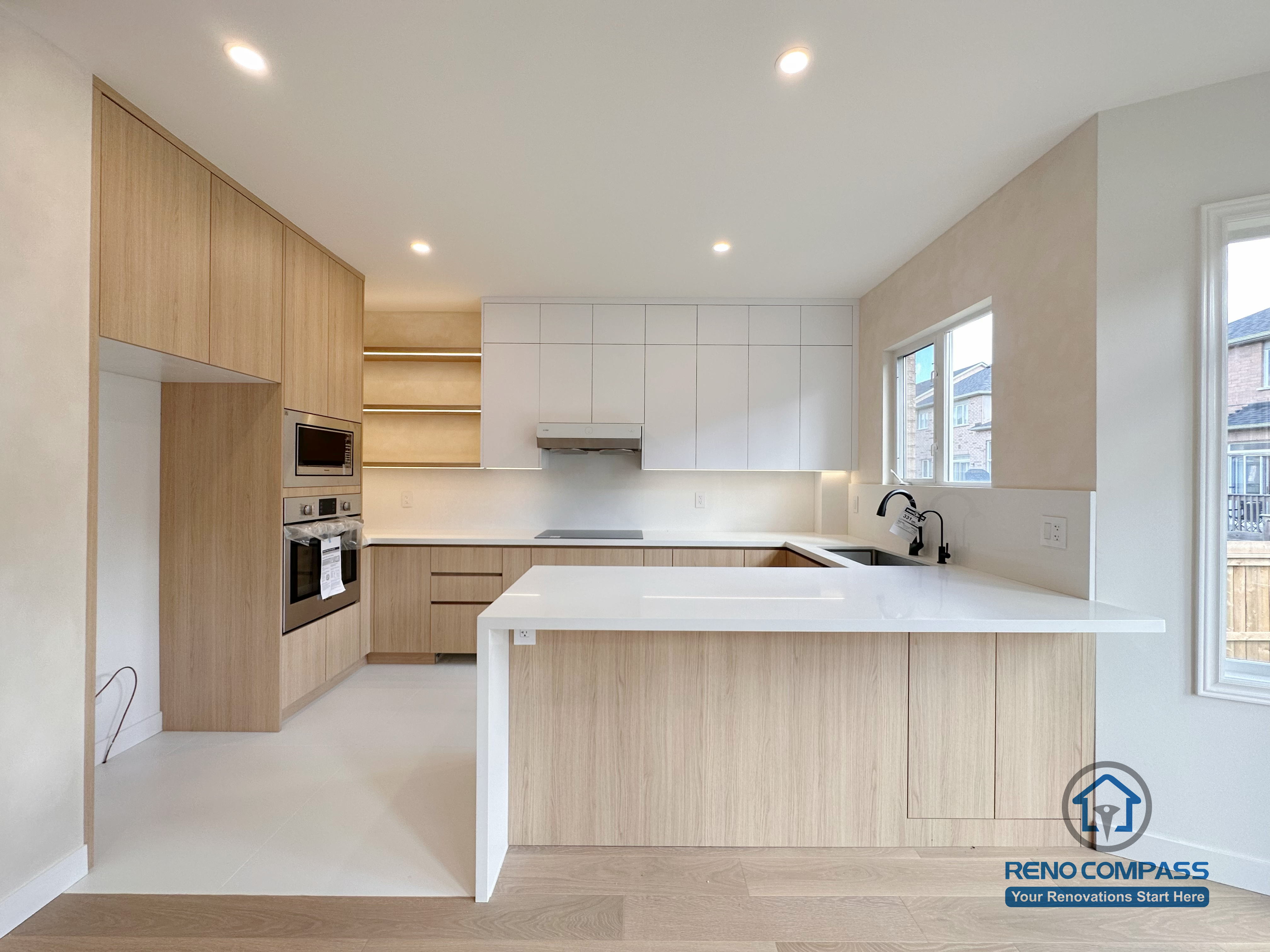This Markham kitchen renovation features custom wood cabinetry, a spacious central island, and integrated appliances designed to enhance daily functionality. The clean layout, soft lighting, and neutral finishes create a bright, modern kitchen optimized for workflow and long-term use.
