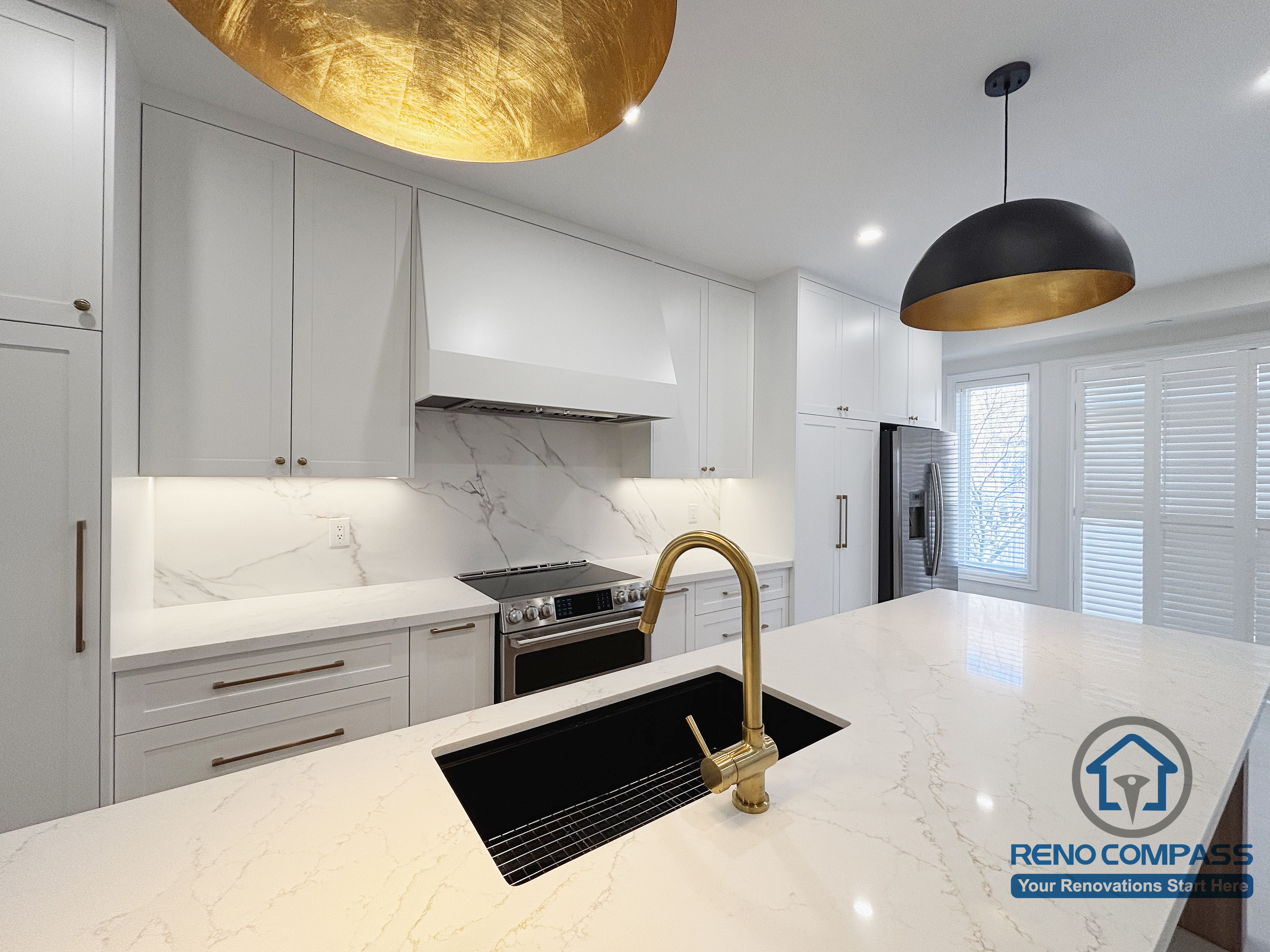 This Oakville kitchen renovation highlights the primary cooking zone, featuring a marble-style backsplash, clean-lined cabinetry, and a well-positioned island sink that supports efficient meal preparation. The coordinated surfaces and fixtures create a seamless transition between cooking and prep areas, while pendant lighting provides focused illumination without disrupting visual balance. Completed by Reno Compass, this kitchen design emphasizes clarity, functionality, and long-term practicality for everyday use in an Oakville home.
