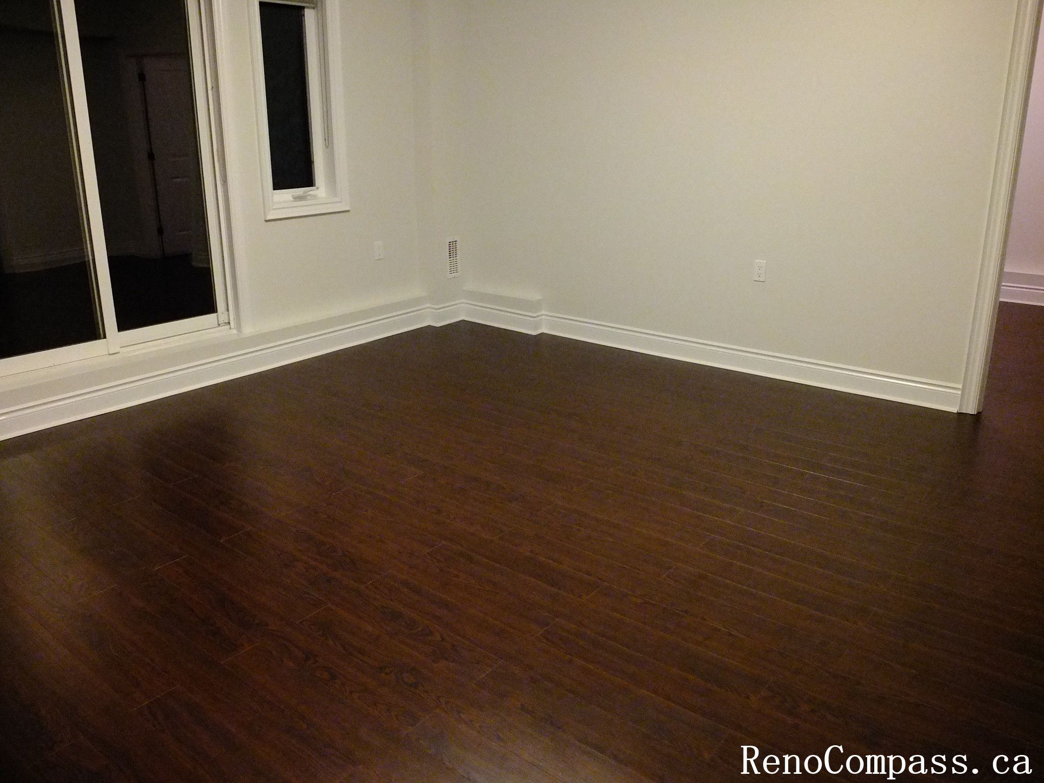 Beautiful dark hardwood flooring installation in a renovated Richmond Hill home. Modern interior design with smooth floor finish and elegant staircase craftsmanship. Completed by RenoCompass.ca for a high-quality residential remodel.