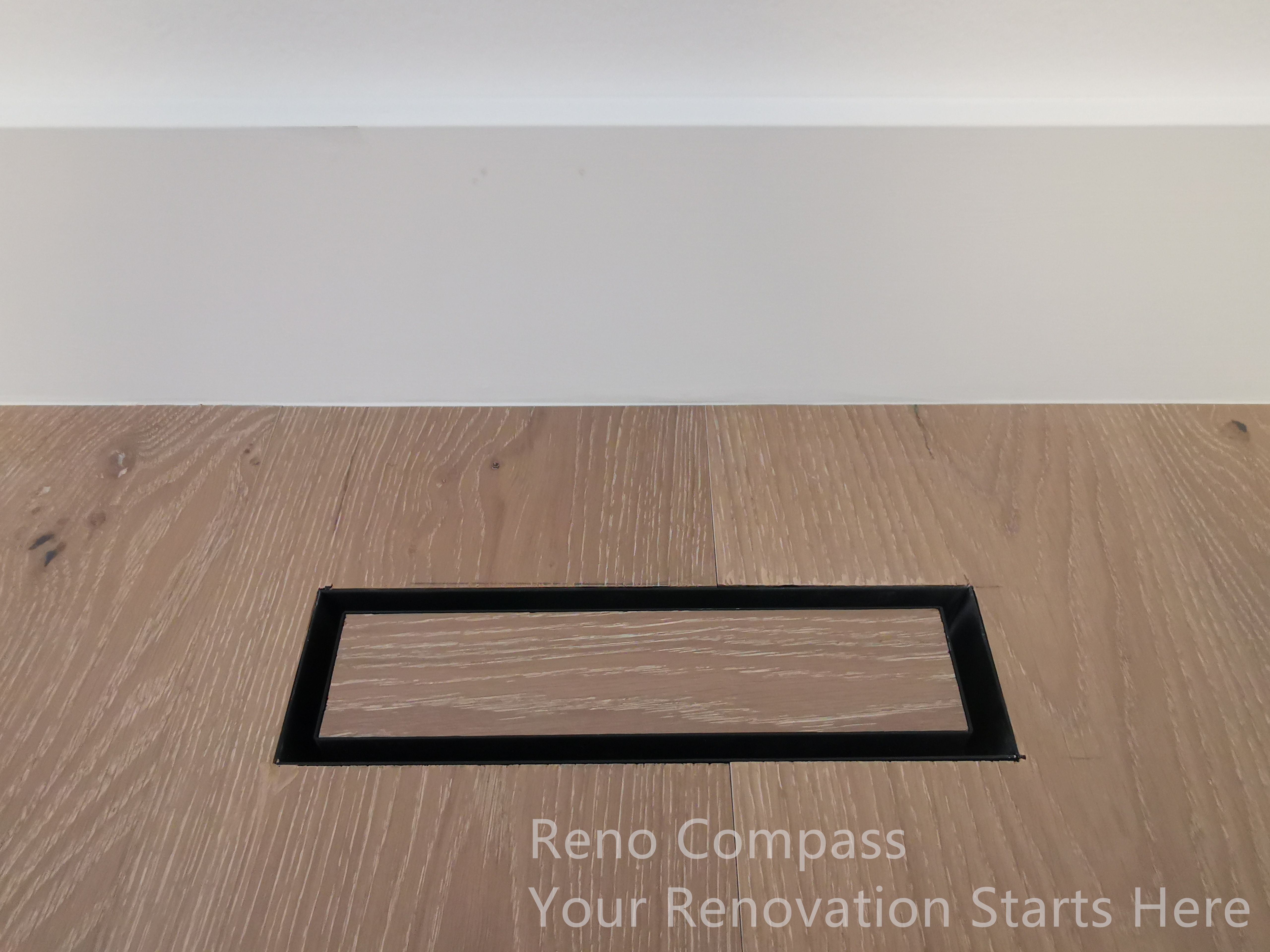 This image highlights a flush-mounted floor vent detail completed as part of a Markham interior renovation. The vent is carefully integrated into the wood flooring, with a slim black frame that aligns cleanly with the surrounding planks. This detail-oriented approach minimizes visual disruption while maintaining proper airflow and functionality. By aligning mechanical elements seamlessly with finished surfaces, the renovation achieves a refined, modern look that reflects precision workmanship and thoughtful interior planning.