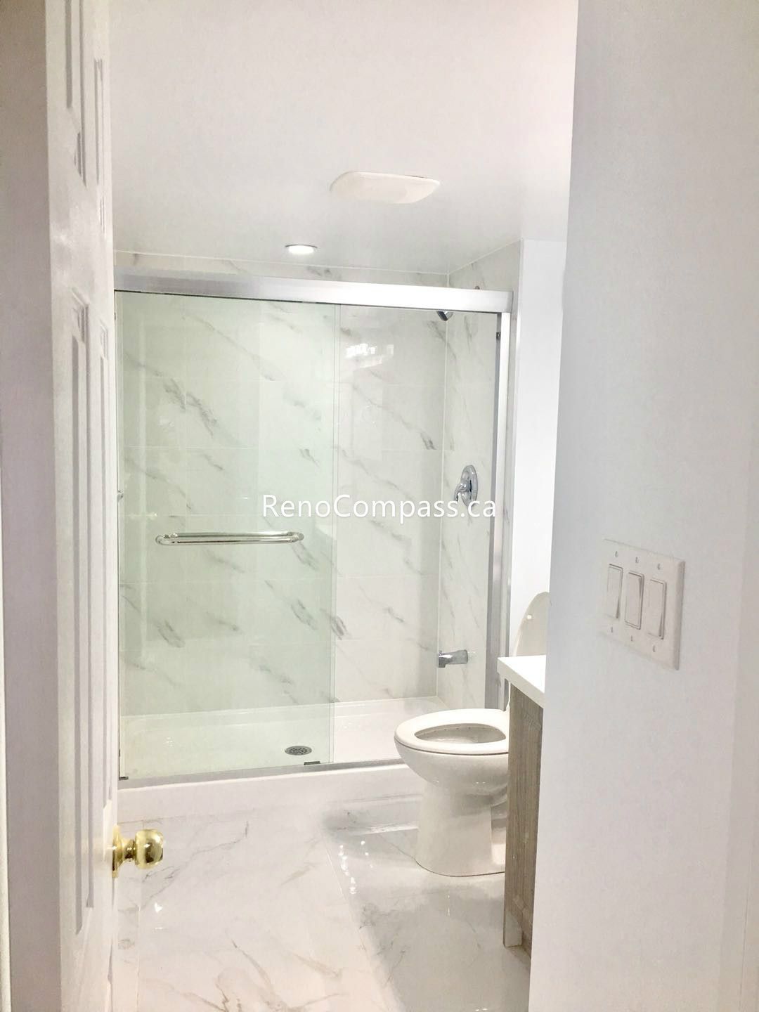 This Toronto basement renovation includes a newly built modern bathroom featuring marble-style wall and floor tiles, a sleek glass shower enclosure, and updated fixtures for a clean contemporary look. The bright design improves functionality and comfort while maximizing space in the finished basement. Completed by a professional Toronto renovation company, this bathroom renovation showcases quality craftsmanship, durable materials, and a stylish upgrade for everyday living.