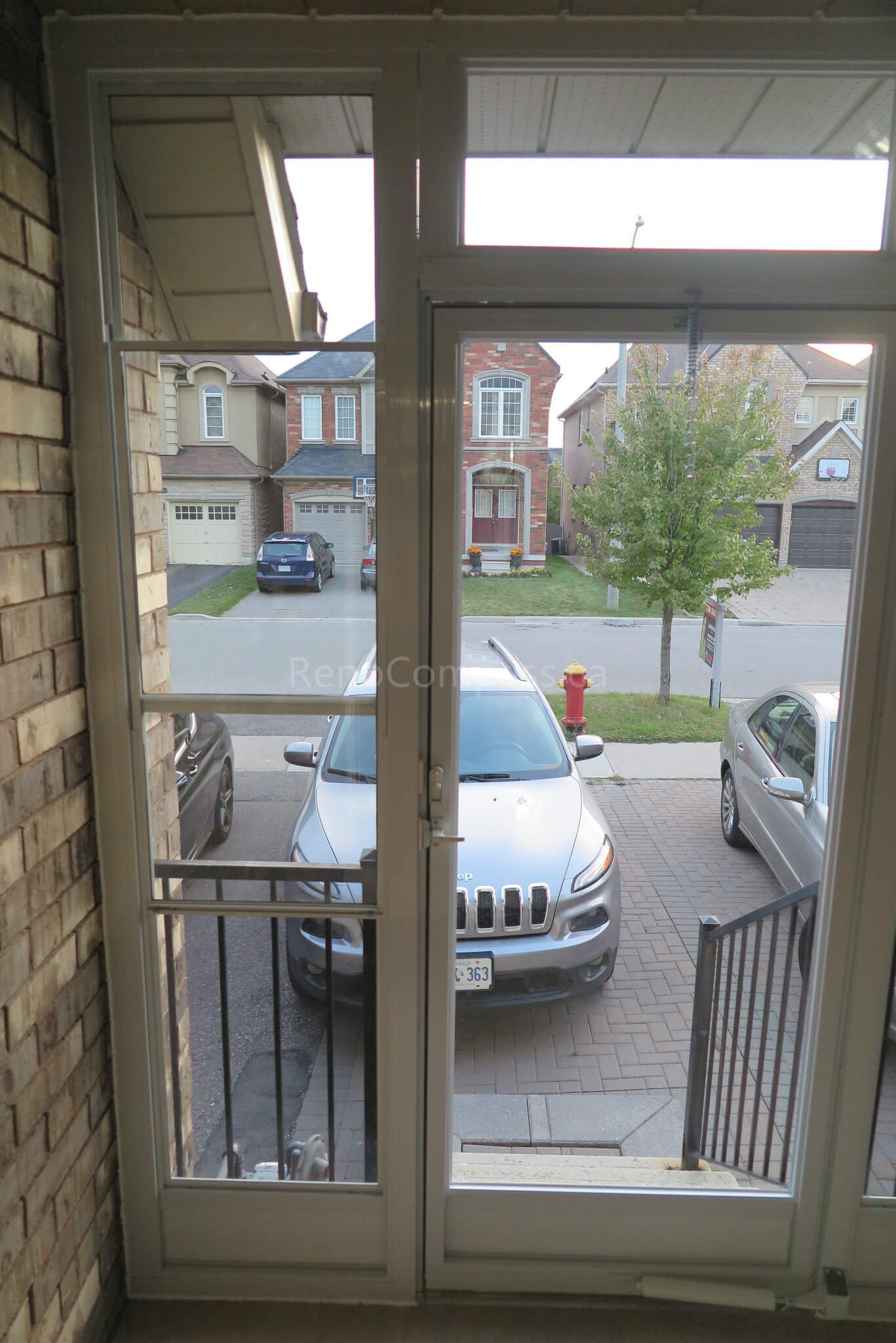 Interior view of a newly installed storm door in a Markham home, completed by Reno Compass Inc. The aluminum-framed glass door enhances natural light entry while providing improved insulation and year-round protection against weather conditions.