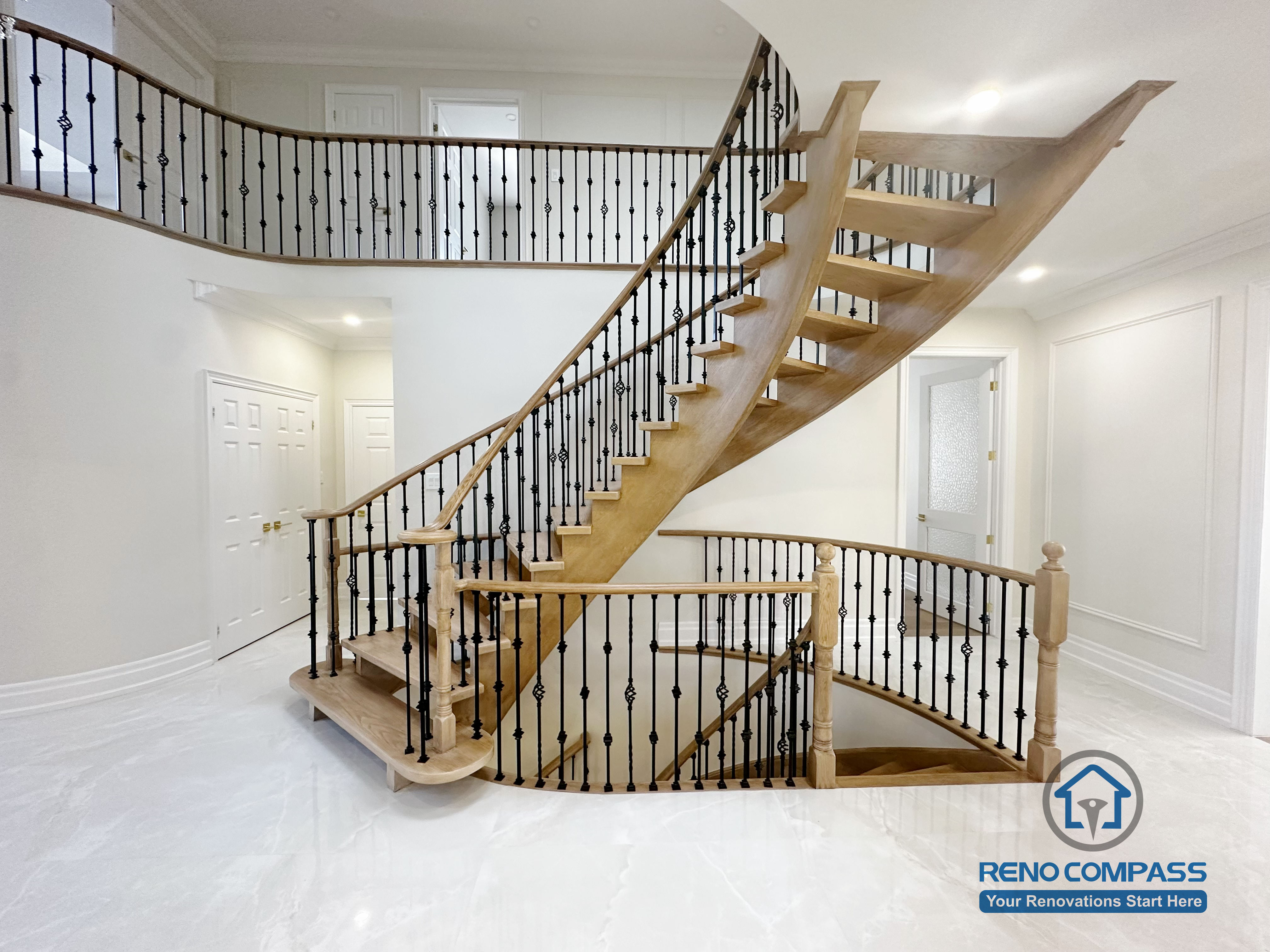 This image showcases the front view of a grand curved staircase as part of a North York flooring and stair renovation. The staircase features solid hardwood treads, smooth curved stringers, and decorative iron balusters, forming a strong architectural focal point at the home’s entrance. The surrounding flooring is finished with polished, light-toned surfaces that enhance brightness and reflect natural light. This renovation highlights precise craftsmanship and seamless coordination between flooring and stair design, creating an elegant and cohesive interior for North York homes.