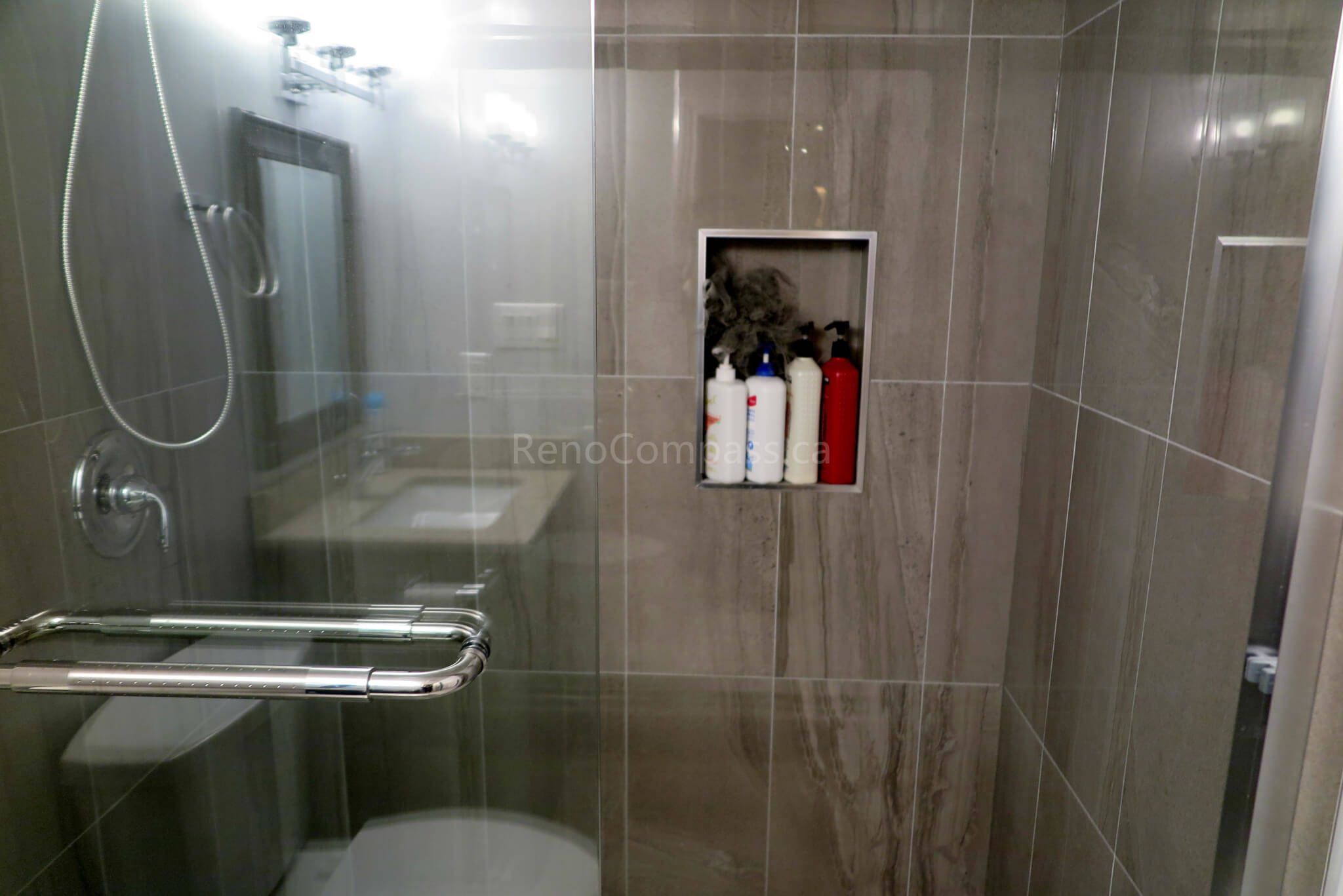 Stylish walk-in shower in the Richmond Hill basement renovation featuring modern tile work, glass enclosure, and rainfall-style showerhead.