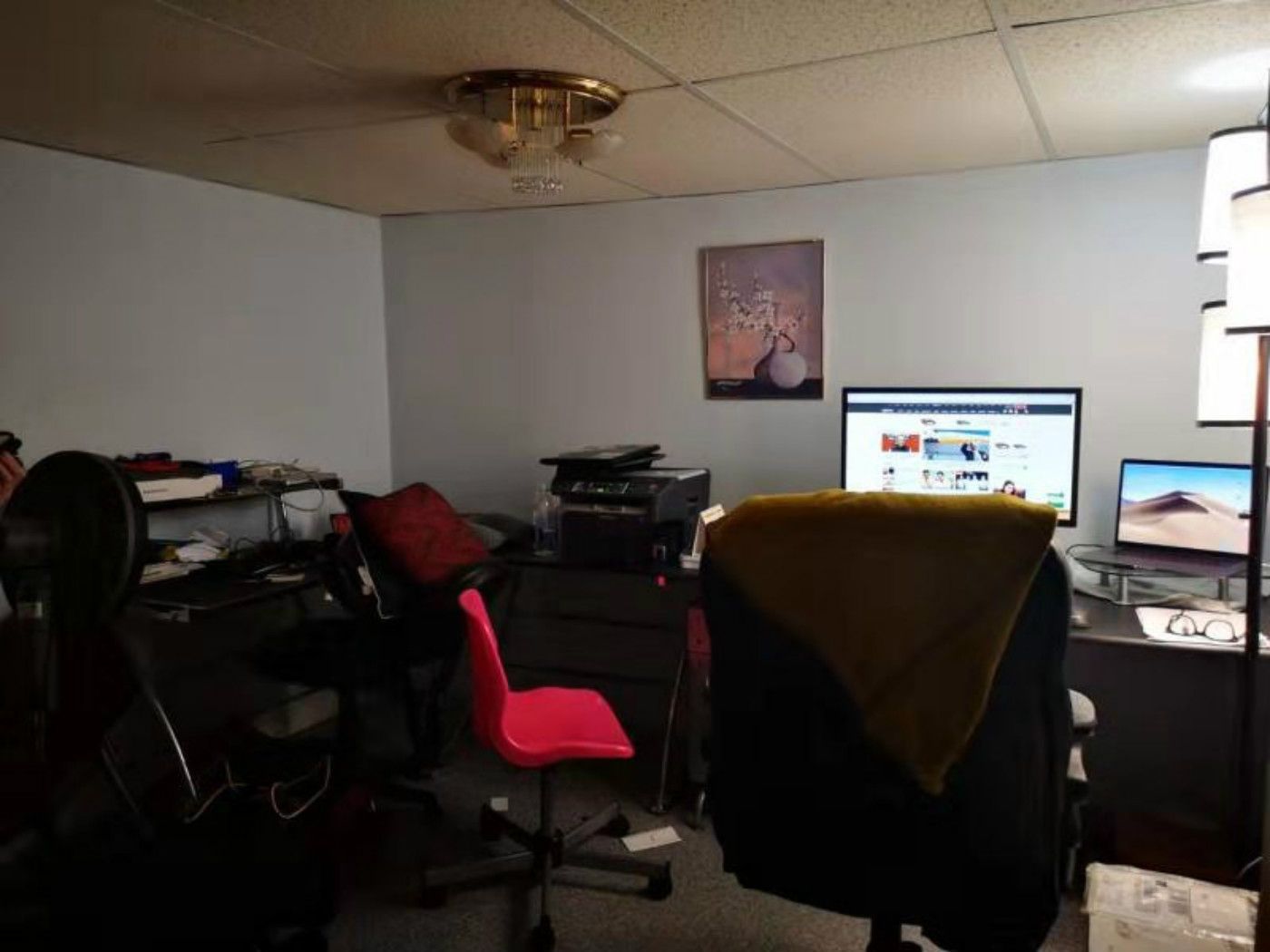 This pre-renovation basement space in Mississauga features a compact home office setup with drop ceiling, basic lighting, and limited layout efficiency. The area highlights the need for improved lighting, space optimization, and modern finishes, setting the foundation for a professional Toronto renovation company to transform it into a functional and stylish workspace.