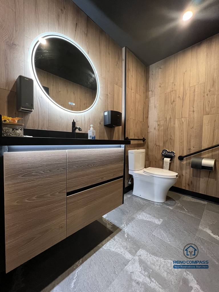 This Mississauga restaurant renovation includes a modern commercial washroom with durable finishes, custom vanity cabinetry, and integrated lighting. The design focuses on easy maintenance, long-term durability, and a clean, professional appearance suitable for high-traffic restaurant use.