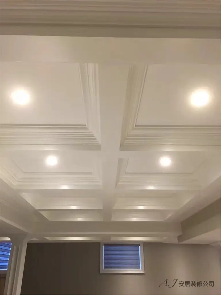 Architectural coffered ceiling above the staircase featuring recessed LED lighting and decorative trim detailing. This Toronto interior renovation enhances the vertical space with elegant ceiling craftsmanship and balanced lighting by a professional Toronto renovation company.