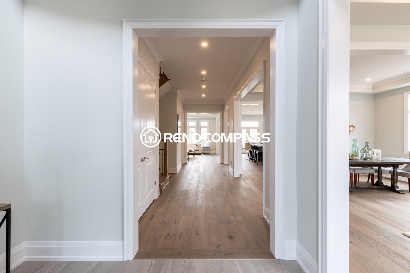 This image showcases a Newmarket flooring renovation project in the Toronto area, featuring professionally installed engineered wood flooring that enhances both durability and aesthetics. Engineered wood floors are constructed with multiple cross-layered wood boards, providing greater structural stability compared to traditional solid hardwood while maintaining the same natural appearance and comfortable feel. This type of flooring is popular among homeowners for its resistance to expansion, warping, and seasonal humidity changes. The project demonstrates clean installation, smooth finishing, and a modern interior look, completed by Reno Compass Inc., a Toronto renovation company specializing in flooring installation and interior upgrades.
