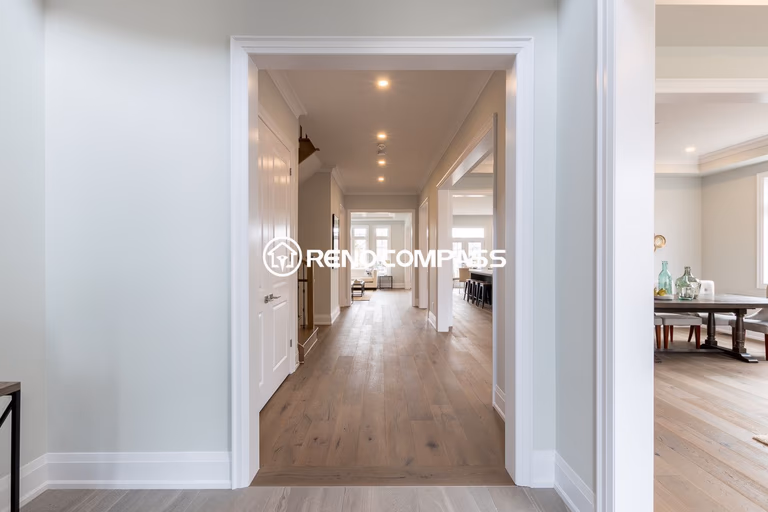 This image showcases a Newmarket flooring renovation project in the Toronto area, featuring professionally installed engineered wood flooring that enhances both durability and aesthetics. Engineered wood floors are constructed with multiple cross-layered wood boards, providing greater structural stability compared to traditional solid hardwood while maintaining the same natural appearance and comfortable feel. This type of flooring is popular among homeowners for its resistance to expansion, warping, and seasonal humidity changes. The project demonstrates clean installation, smooth finishing, and a modern interior look, completed by Reno Compass Inc., a Toronto renovation company specializing in flooring installation and interior upgrades.