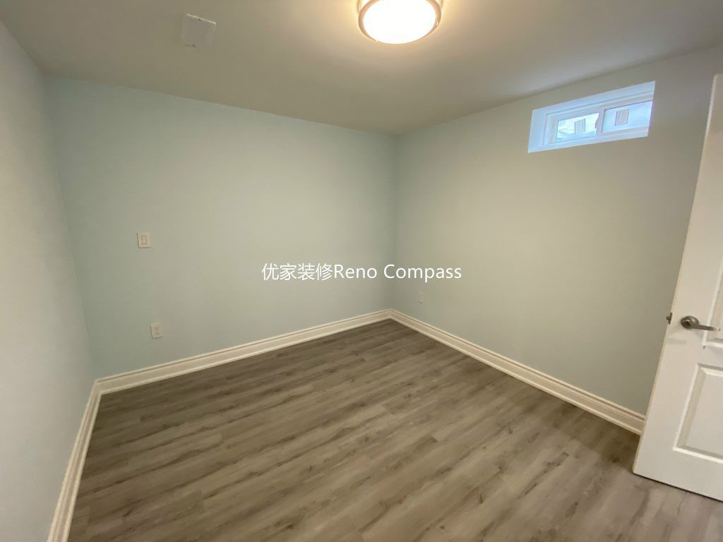 This Aurora basement renovation includes a newly finished basement bedroom completed by a professional Toronto renovation company. The space features durable modern vinyl flooring, fresh neutral wall paint, updated baseboards, and bright ceiling lighting to create a clean and comfortable living environment. A functional layout with proper window placement allows for natural light while maintaining privacy, making the room ideal for guest use, rental potential, or extended family living. Contractor: Reno Compass Inc.