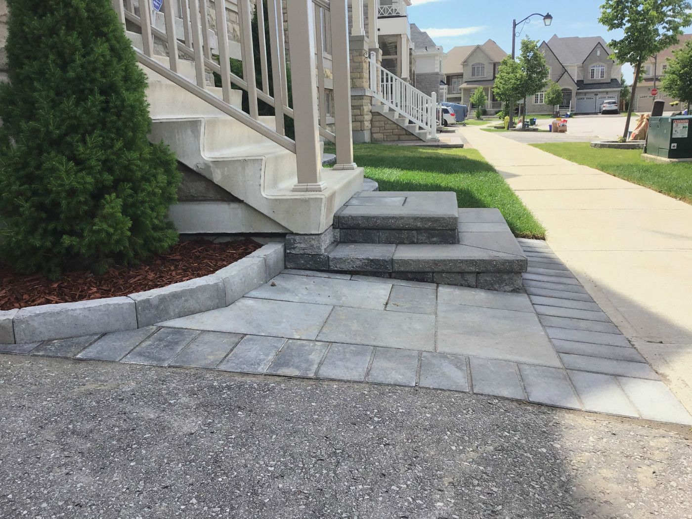 This Markham landscaping renovation highlights a professionally installed interlocking stone walkway and multi-level front entrance steps. The combination of clean lines and durable materials enhances both accessibility and curb appeal, creating a welcoming and long-lasting exterior upgrade.