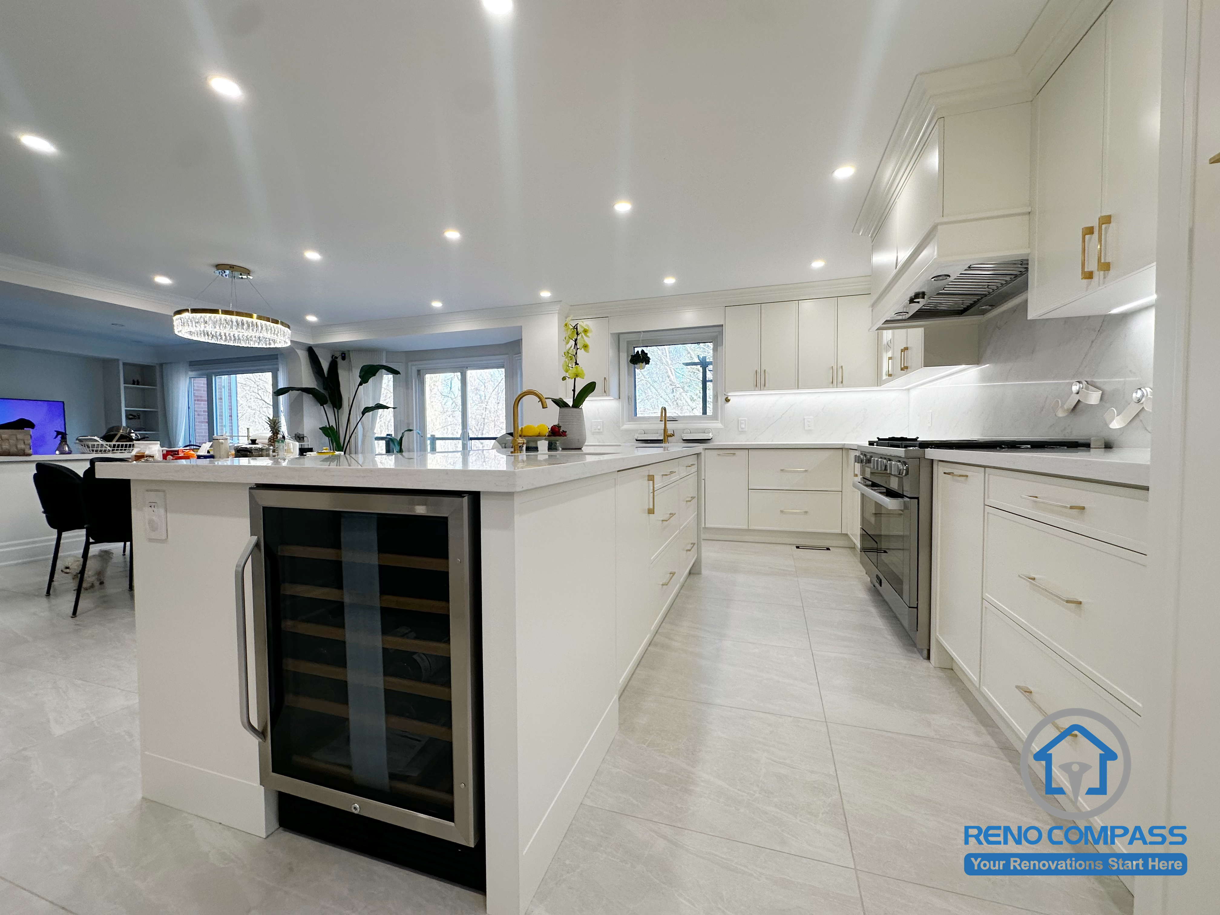 This Markham kitchen renovation features a spacious island designed to support food preparation, storage, and casual entertaining. An integrated wine fridge adds convenience, while custom white cabinetry, quartz countertops, and recessed lighting create a bright, open kitchen environment that connects seamlessly with the surrounding living space.