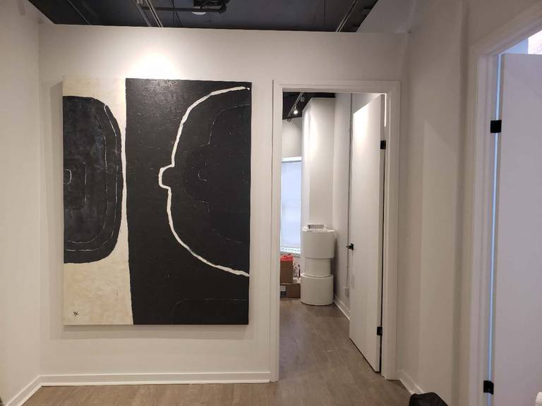 This image showcases a modern hallway and feature art wall within a beauty and massage spa, completed by a professional Toronto renovation company specializing in commercial interior renovations. The space highlights clean wall finishes, contemporary artwork installation, and strategic lighting that enhances visual depth and brand identity. Durable wood-look flooring and a streamlined corridor layout ensure smooth client flow between treatment rooms while maintaining a calm and upscale spa atmosphere. This design approach is ideal for wellness clinics, beauty studios, and medical spa interiors across Toronto and the GTA seeking a modern, welcoming, and professionally renovated environment.