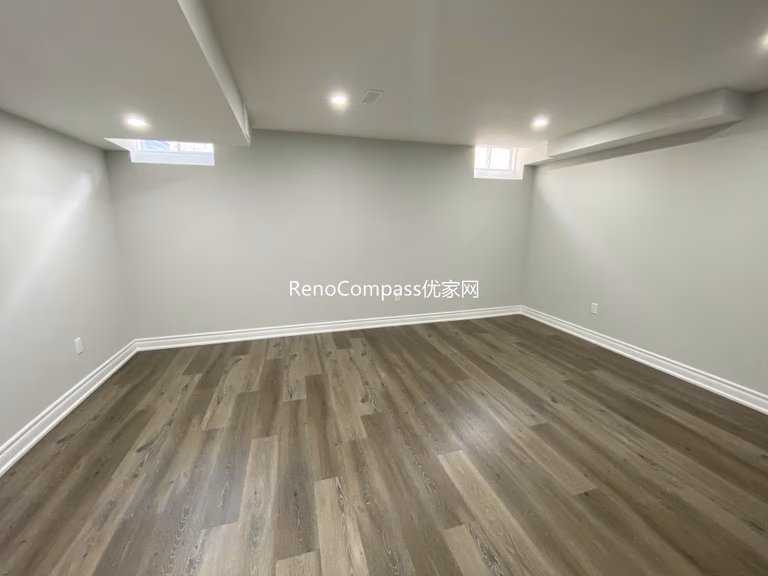 Spacious living area renovation featuring premium wood flooring and smooth neutral paint finish, creating a cozy and clean modern home by Reno Compass in Richmond Hill.