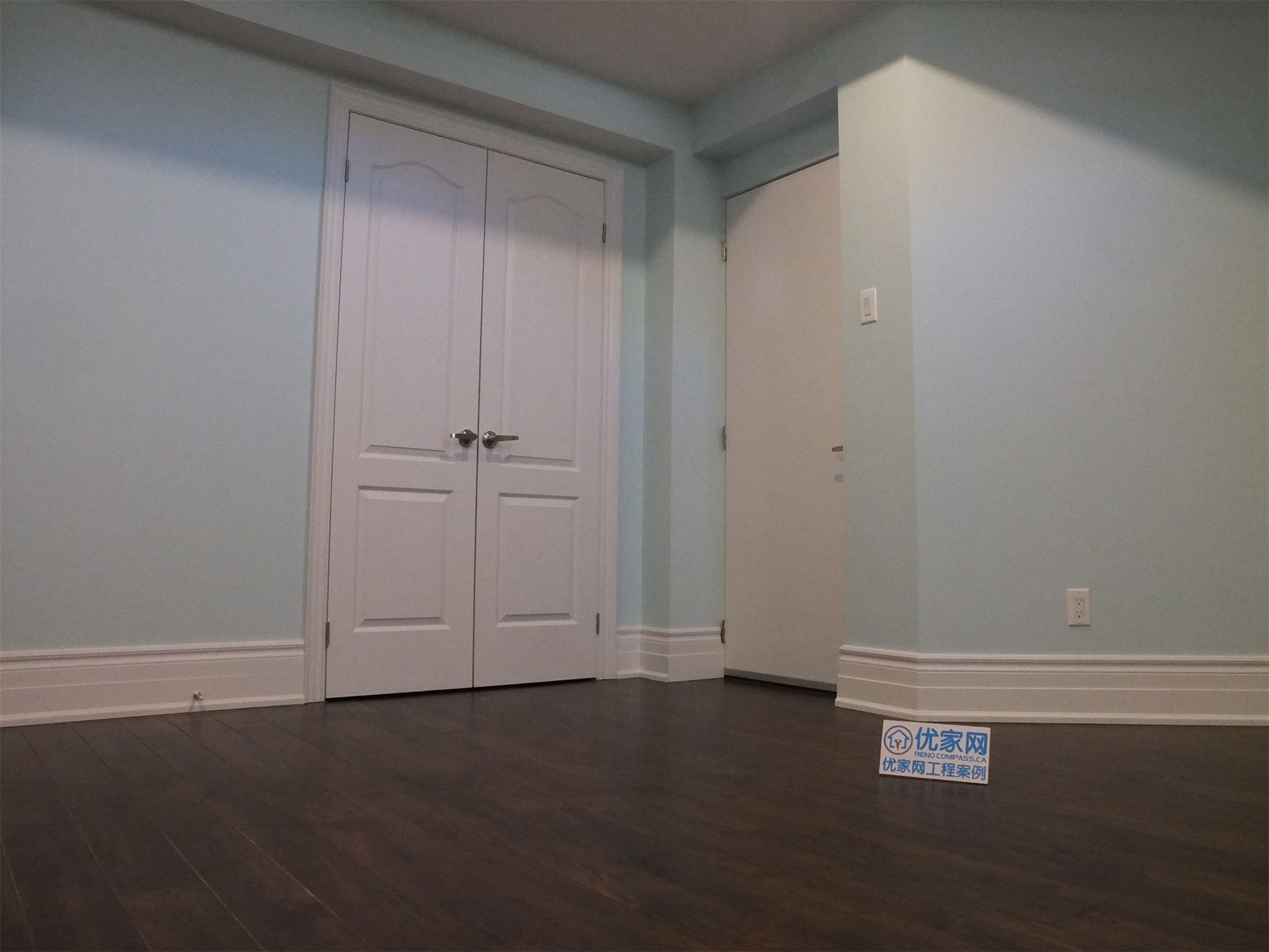This Richmond Hill basement renovation features a finished bedroom with built-in closet storage, smooth wall finishes, and dark hardwood flooring. The space is designed for comfort and functionality, making it ideal for a guest room, home office, or rental basement unit.