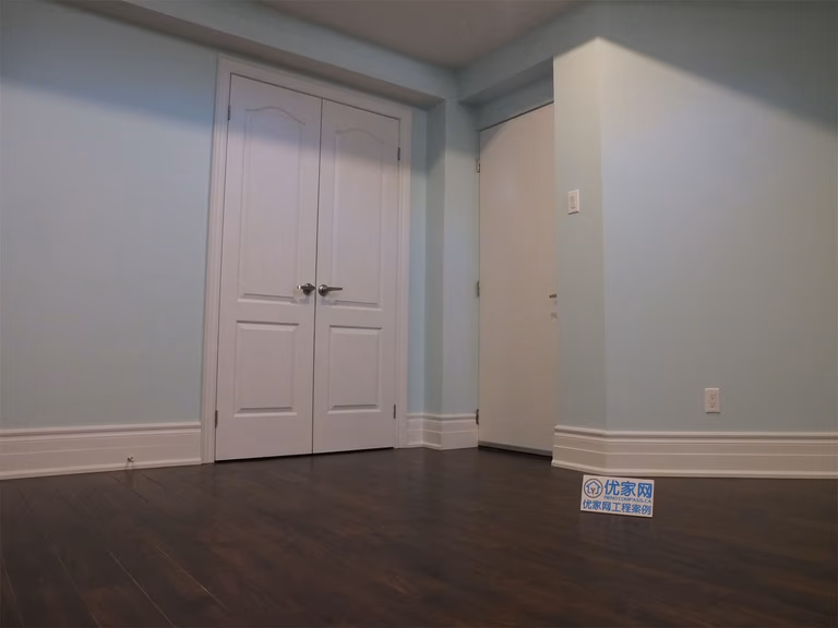 This Richmond Hill basement renovation features a finished bedroom with built-in closet storage, smooth wall finishes, and dark hardwood flooring. The space is designed for comfort and functionality, making it ideal for a guest room, home office, or rental basement unit.