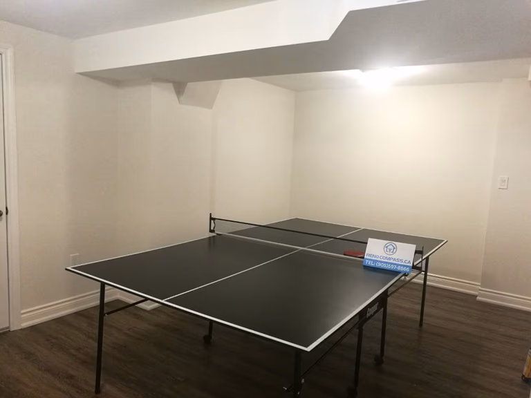 This Markham basement renovation transforms an underused space into a clean and functional multi-purpose entertainment area. The finished basement features durable wood-look flooring, smooth white walls, upgraded lighting, and an open layout suitable for games, family activities, or home recreation. Completed by a professional Toronto renovation company, this basement renovation focuses on comfort, flexibility, and long-term usability for everyday living.