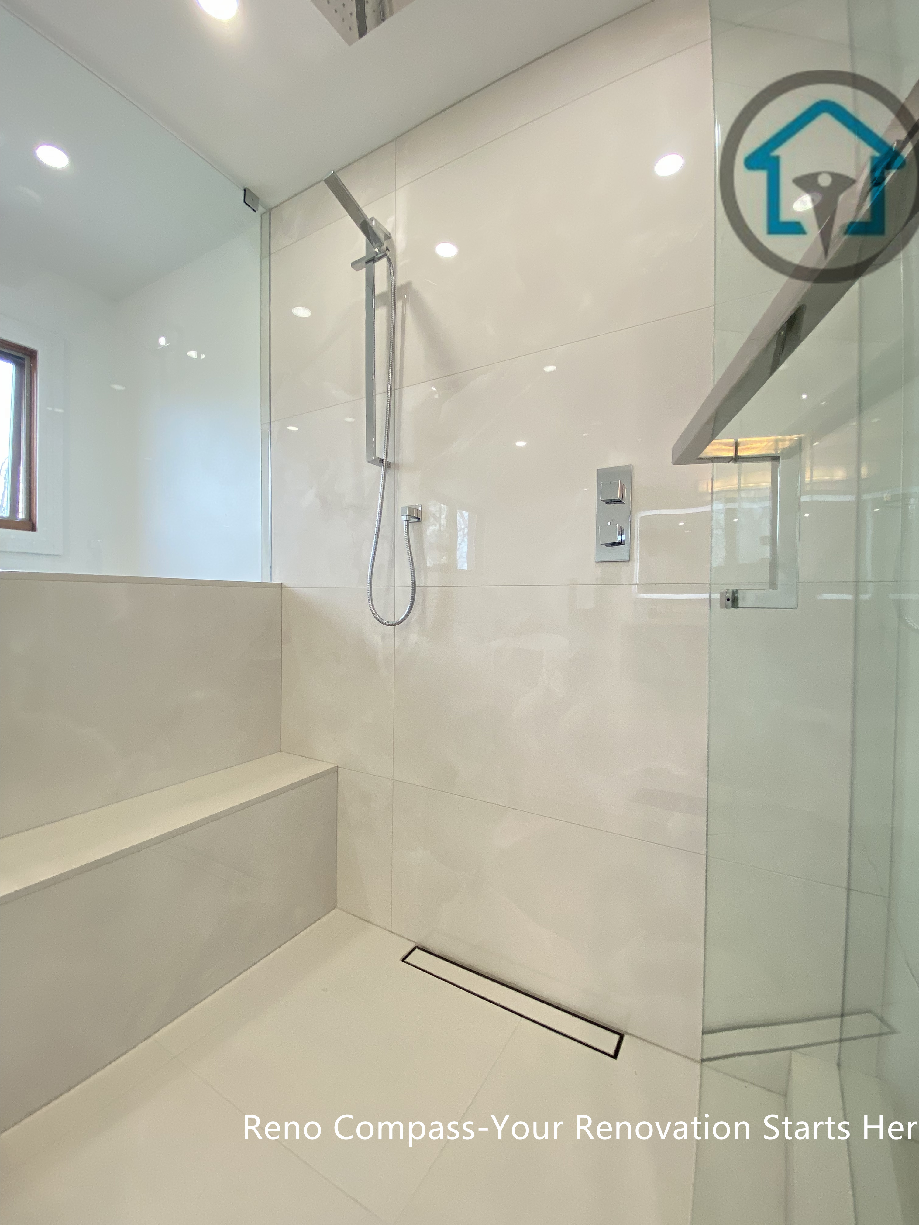 Modern bathroom renovation in Brampton featuring a curbless walk-in shower with large-format porcelain tiles, frameless glass enclosure, and linear floor drain. This design enhances accessibility, improves water drainage, and creates a clean, seamless modern look. Completed by a professional Toronto renovation company, this bathroom upgrade focuses on durability, safety, and long-term everyday comfort.